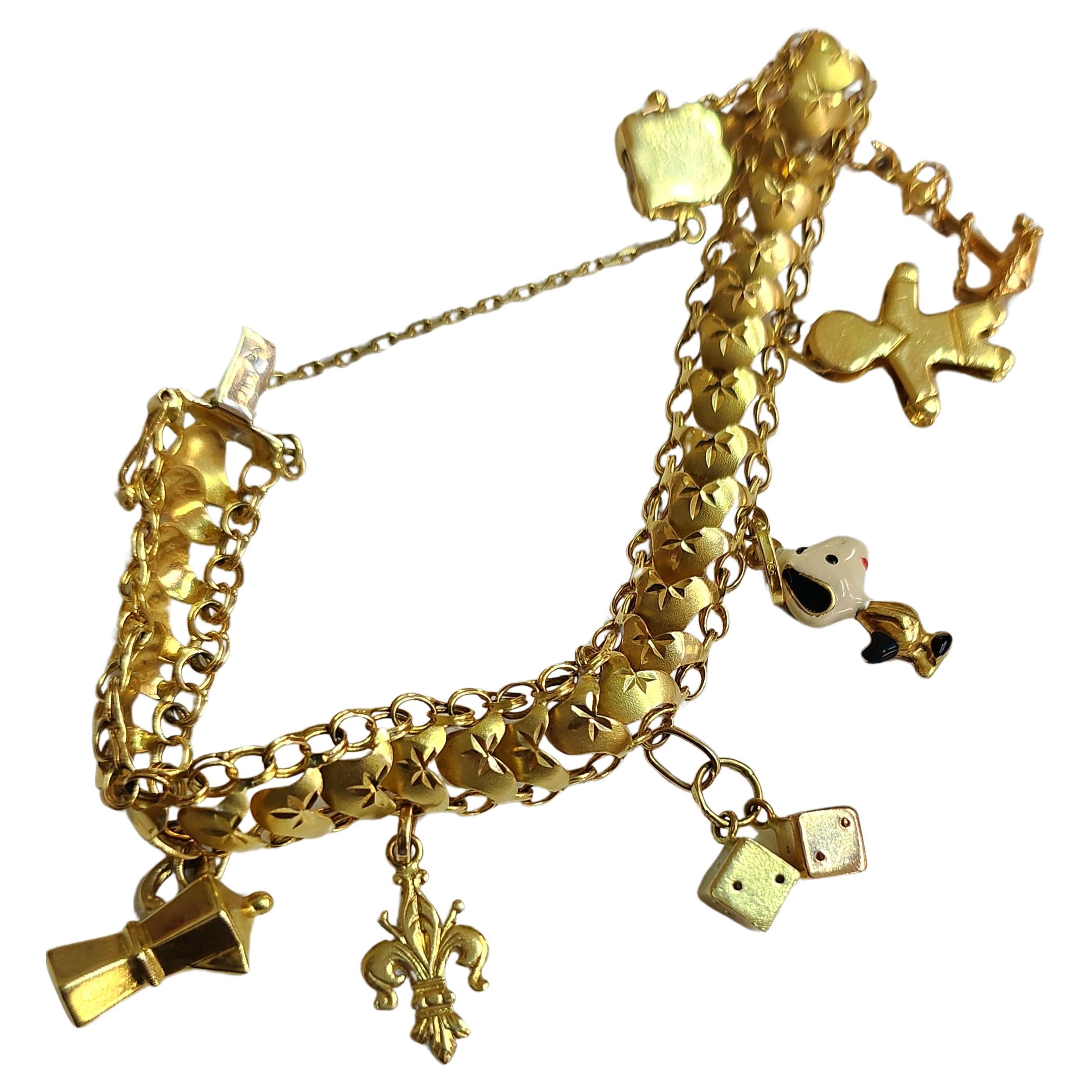 Vintage 1970s 18k gold bracelet with 6 dangling charms in very good condition hall marked and gold tested