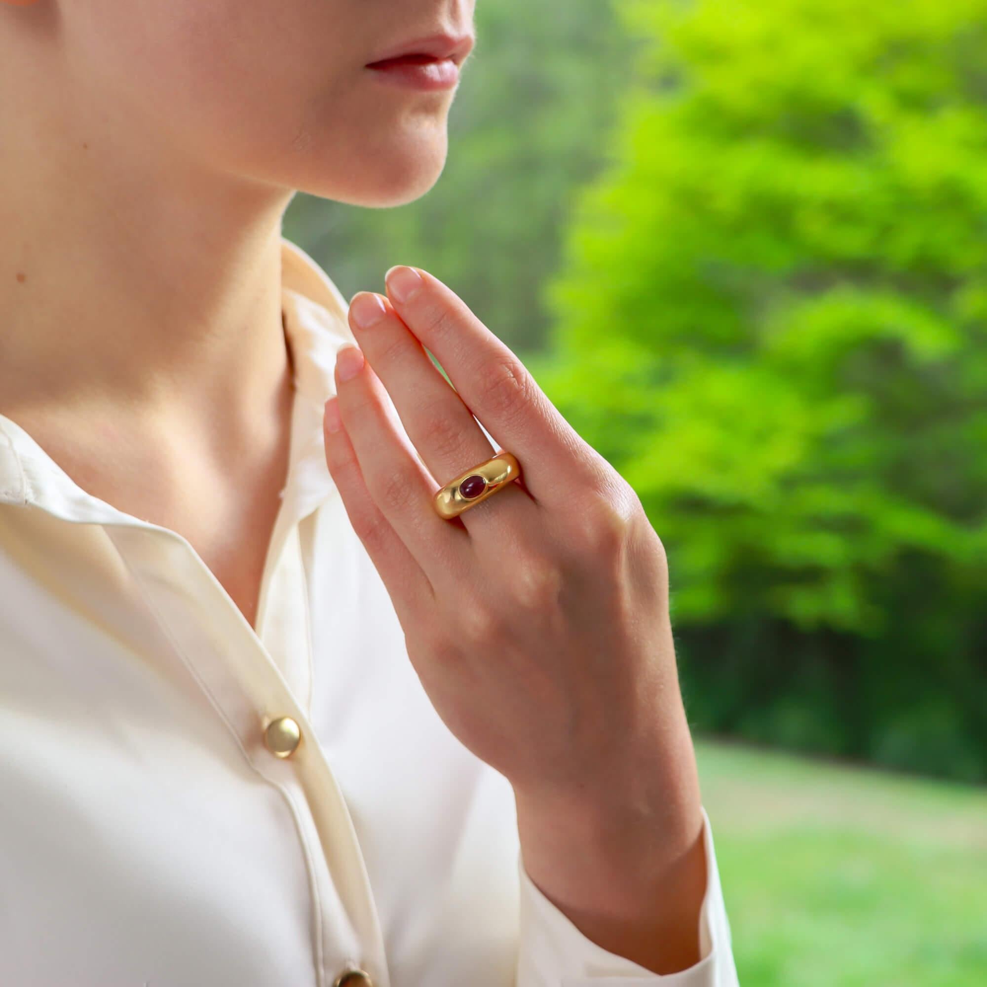 A stylish vintage Chaumet ruby gypsy chunky band ring set in 18k yellow gold.

The ring is solely set with a cabochon vibrant red ruby stone that is bezel set securely in a bombe chunky style band.

Due to the design and size, this ring could be