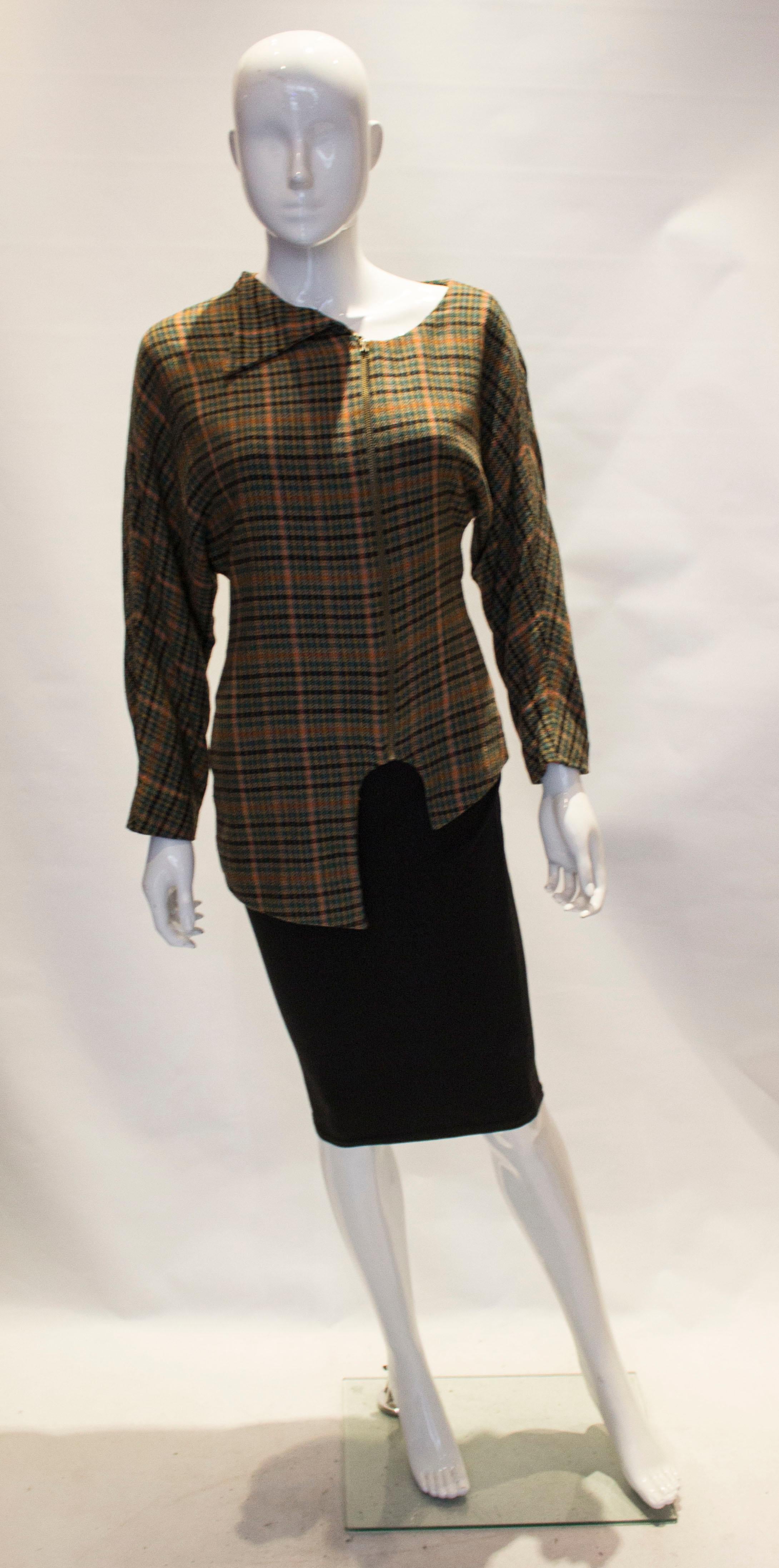 A great vintage jacket with an interesting  and unusual neckline and hemline. The jacket is in a colourful check, has a front zip fastening and is fully lined. Bust 34',' length 31''