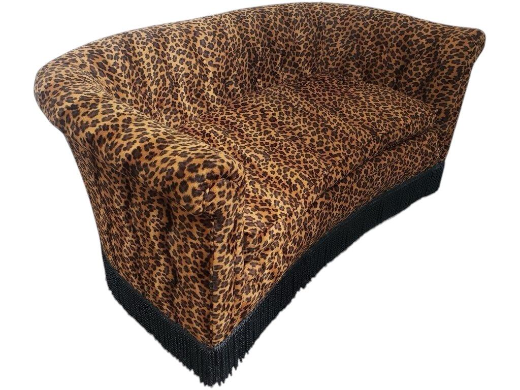 Infuse your space with bold style and undeniable flair with this Vintage Cheetah Print Love Seat. A statement piece that blends classic elegance with a touch of the wild, this loveseat features a striking cheetah print upholstery that adds an