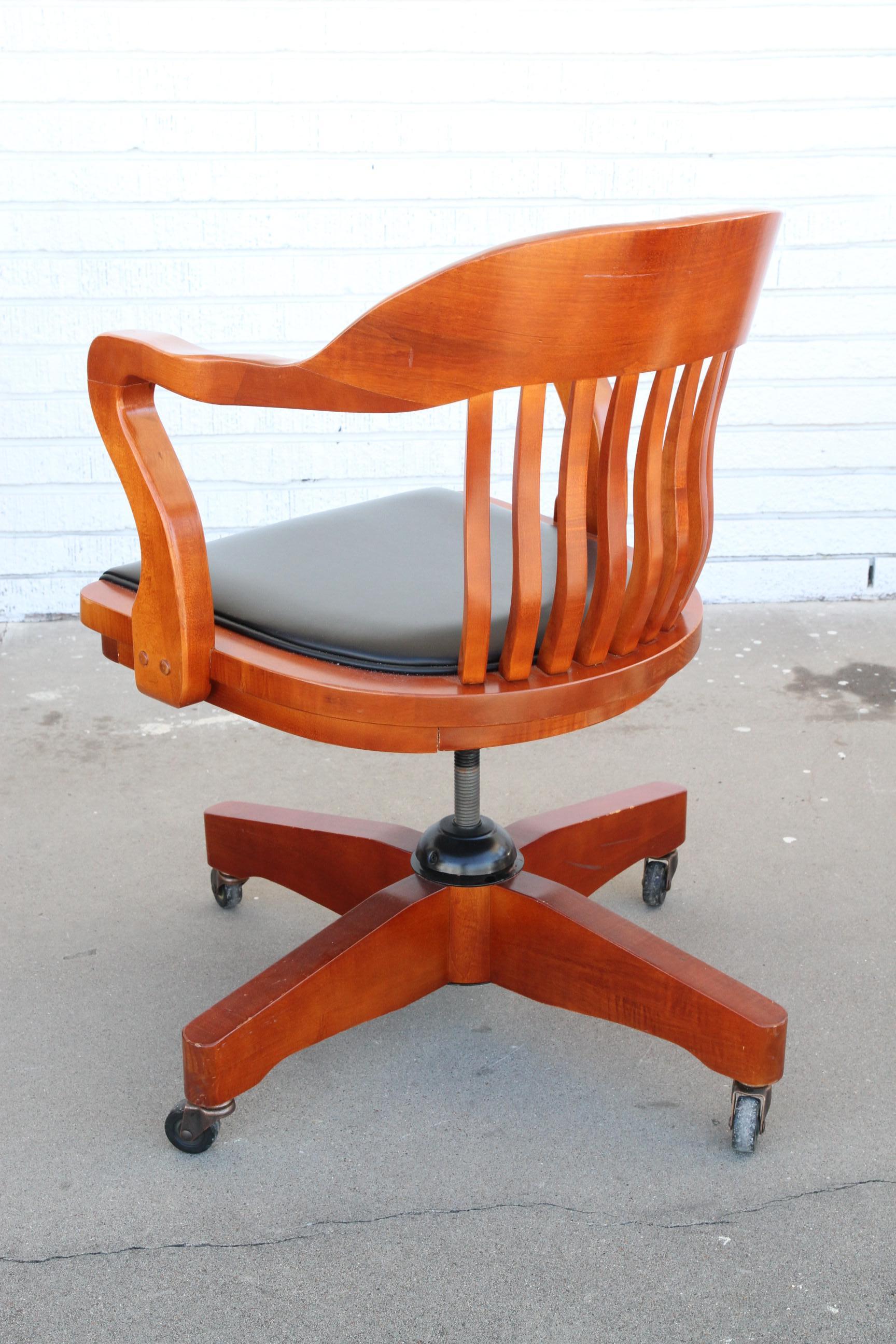 These chairs have ribbed backs and sculptural arms. They're made of Cherry wood and have casters. They're adjustable and they swivel. They would make a nice addition to your office.

Price is for one item.
Chairs swivel.
12 chairs available.
