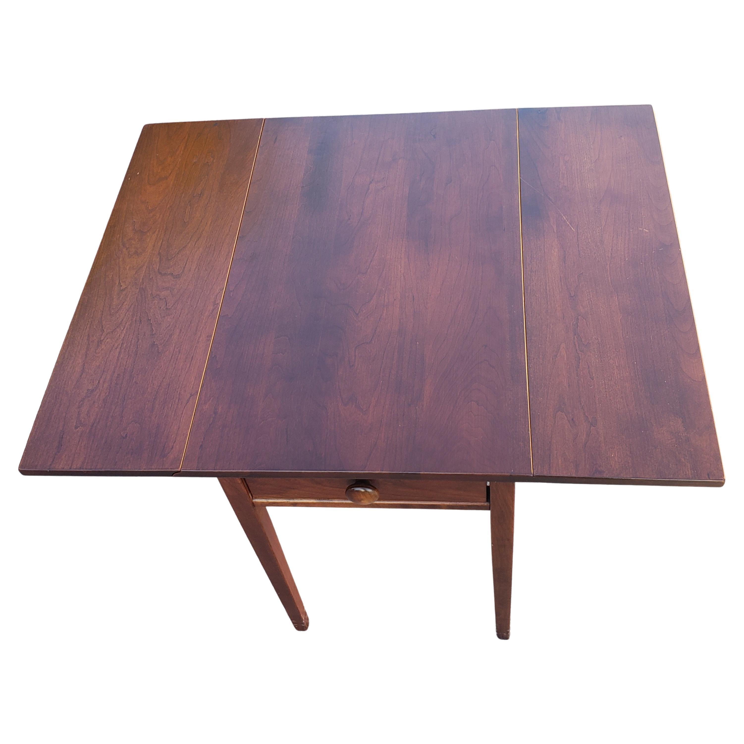 A 1970s vintage drop-leaf Pembroke side table in solid cherry.
Measures 32