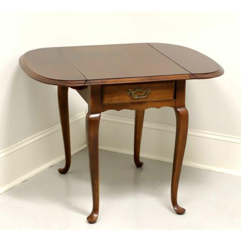 A Queen Anne style drop-leaf side table by Lane. Solid cherry with brass hardware, cabriole legs and pad feet. Features drop leaves and one drawer of dovetail construction. Made in the USA, in the late 20th Century.

Measures: 19 W 26 D 24.5 H,