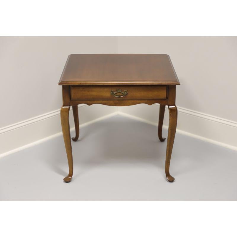 A Queen Anne style square side table by Lane. Solid cherry with cabriole legs and pad feet. One dovetailed drawer with brass hardware. Made in the USA in the late 20th Century.

Measures: 26 W 26 D 24.25 H

Very good vintage condition. Fading to