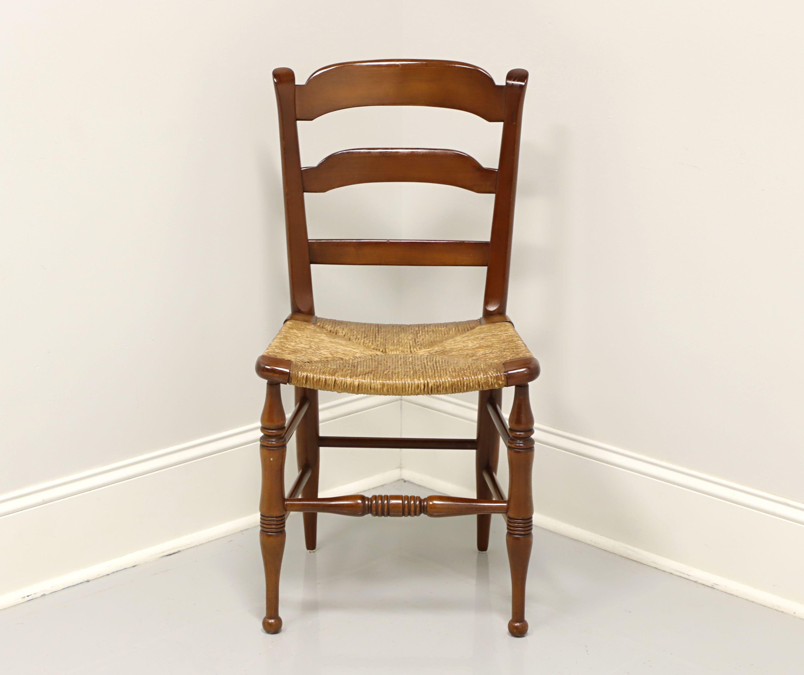 A vintage Cottage style dining side chair, unbranded. Cherry with ladder back design, rush seat, and turned legs. Made in the USA, in the mid 20th century.

Measures: Overall: 17.5W 19D 34.25H, Seat: 17.5W 14.25D 18H

Very good condition with signs