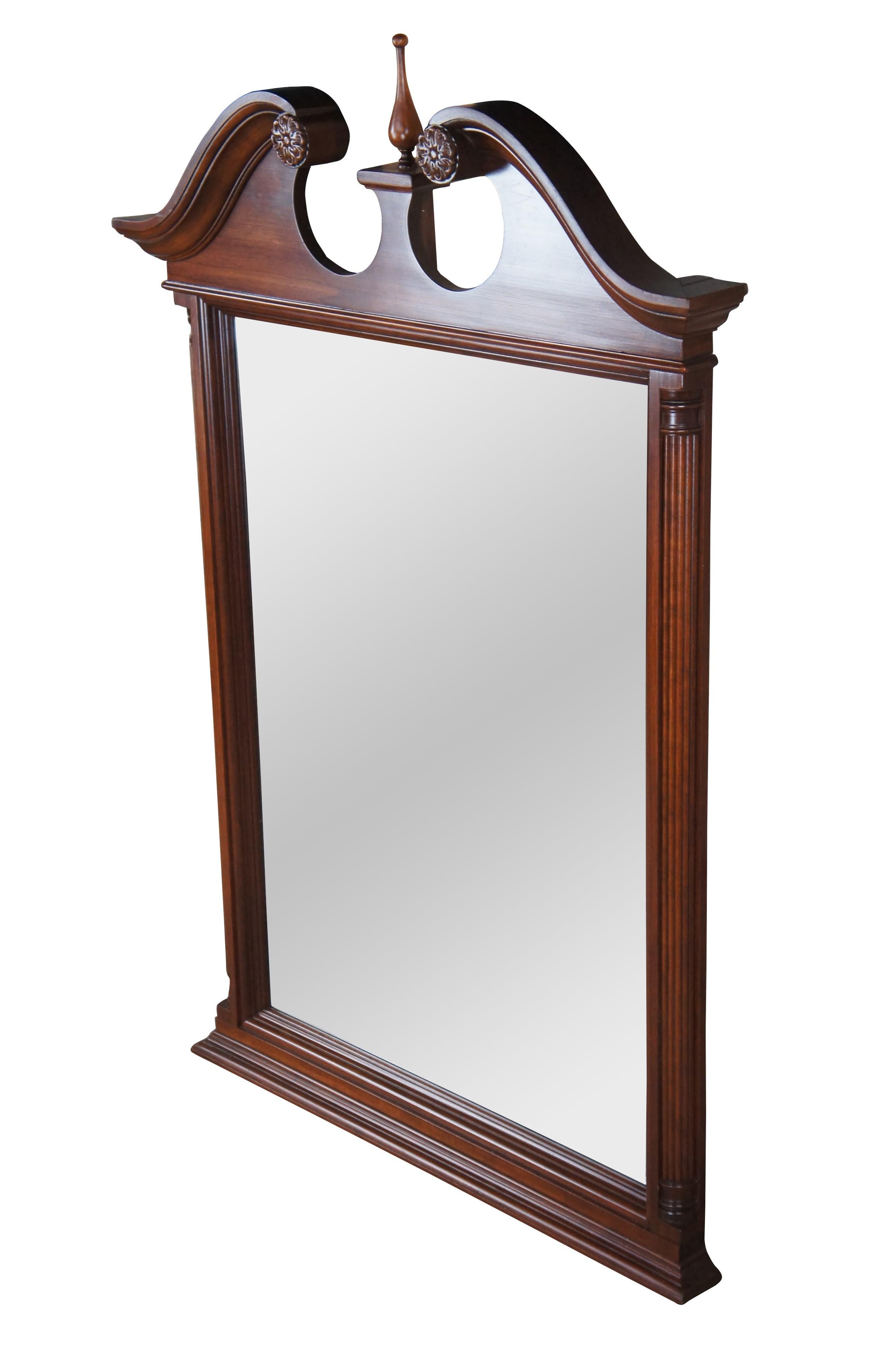 Late 20th Century Chippendale style over mantel or wall hanging mirror.  Made from cherry with an open pediment, spire shaped finial, beveled glass and quarter cut reeded columns along the side.  

Dimensions:
34.5