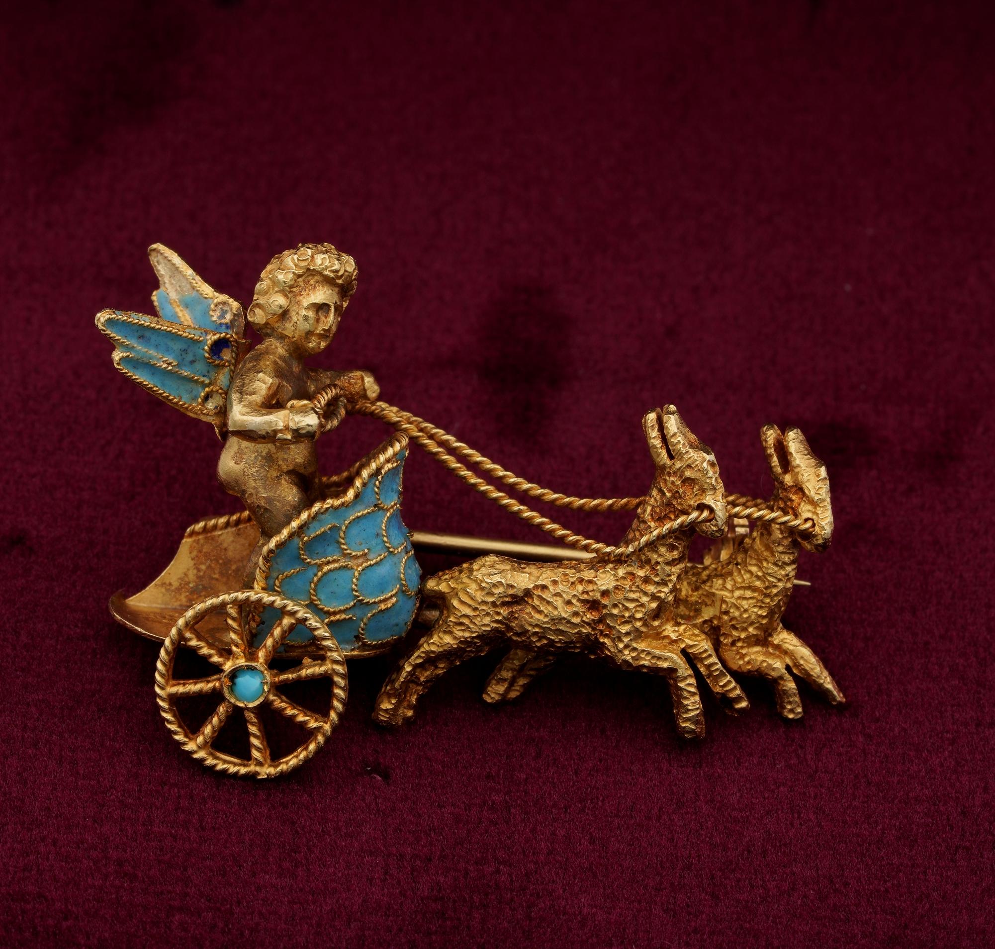 This lovely vintage solid 18 Kt gold hand created brooch is much of a little piece of art made by past Italian masters
The brooch shows a standing winged Cherub or Putto in a chariot being pulled by goats, hunting for love?
The whole is finely
