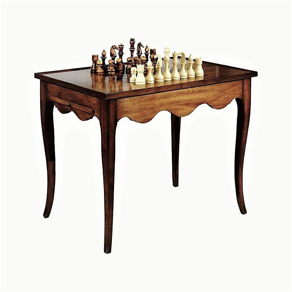 Crafted from solid wood with a rich walnut finish offered is an inlaid combination games table. It features a chess or checkers on the rectangular removable top with a raised molded edge, keeping pieces from slipping off the playing surface. Two
