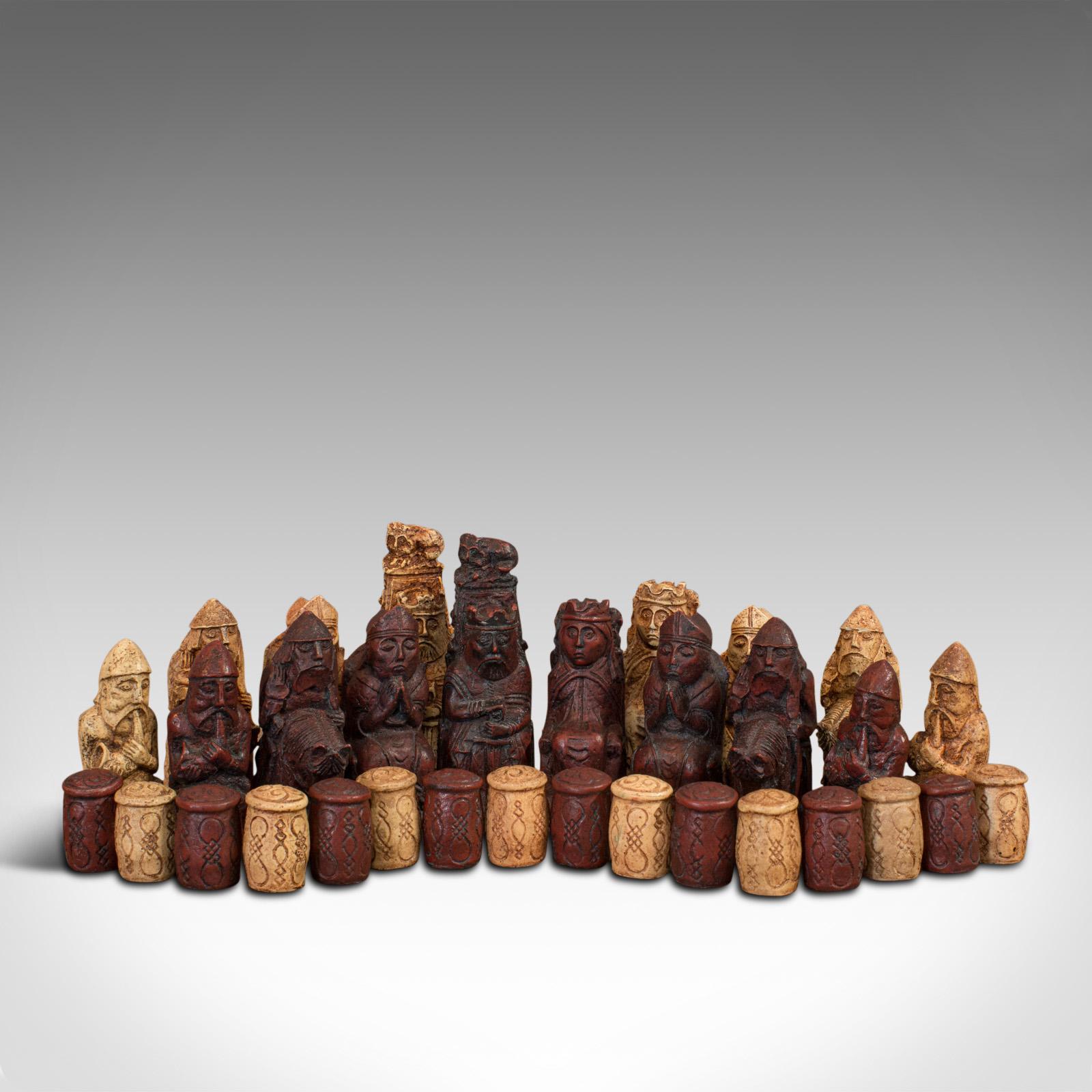 This is a vintage chess set. An English, stone resin gaming set of chess pieces in Gothic taste, dating to the late 20th century, circa 1990.

Appealing medieval-style chess set
Displays a desirable aged patina
Stone resin in good