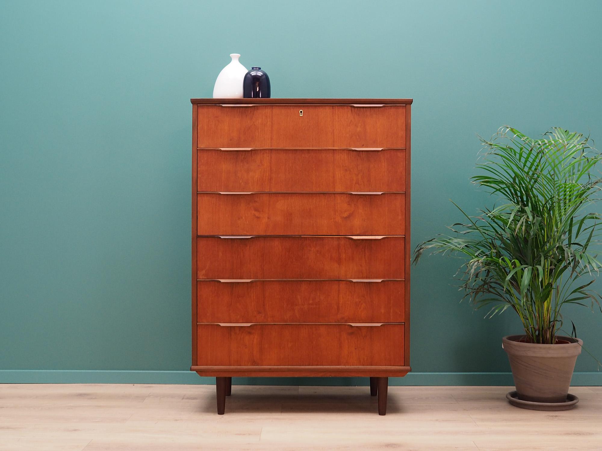 Danish chest of drawers from the 1960s-1970s. Scandinavian design, Minimalist form. The surface of the furniture finished with teak veneer. The chest has six spacious drawers. No key in the set. Preserved in good condition (small bruises and
