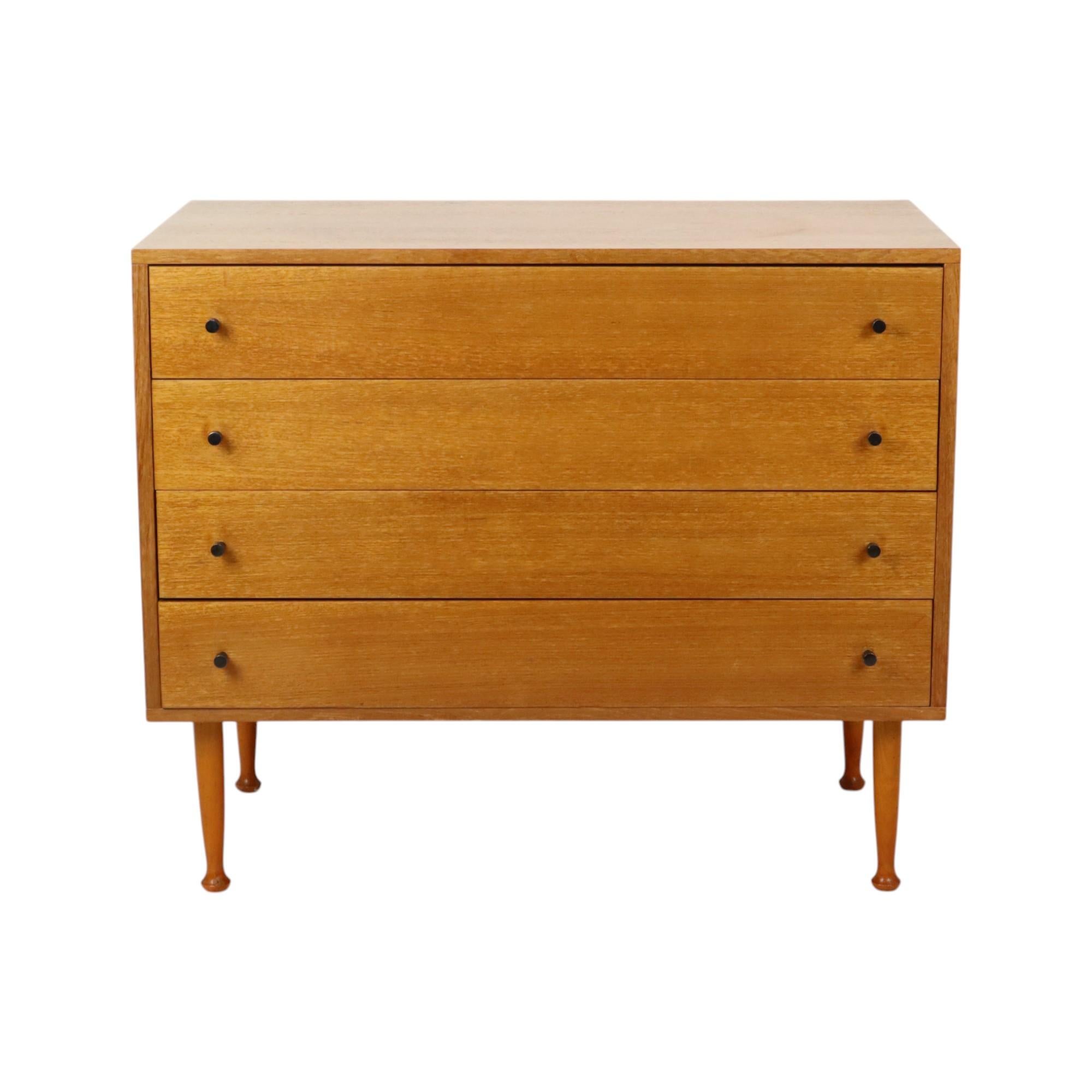 Nice vintage chest of drawers in Scandinavian style, handy cabinet with 4 drawers, light veneer wood and solid drawer fronts with dovetail joints, black metal handles and conical solid wood legs, 60s.

Due to its compact size, this cabinet can shine