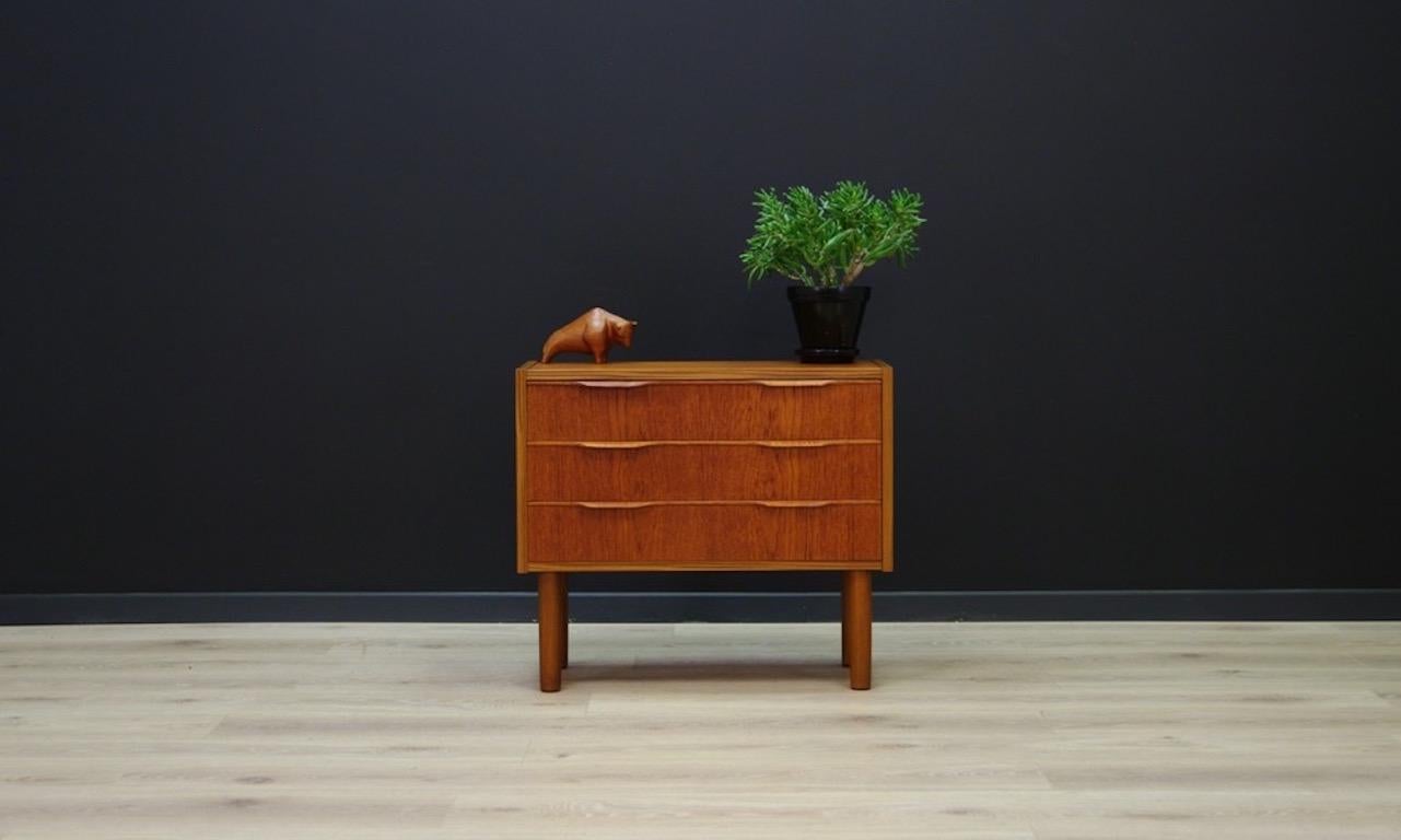 Classical Scandinavian chest of drawers from 1960s-1970s. It has three capacious drawers with solid teak handles. Form veneered with teak. Condition is good with visible small scratches and dings. Product might show slight traces of use, directly
