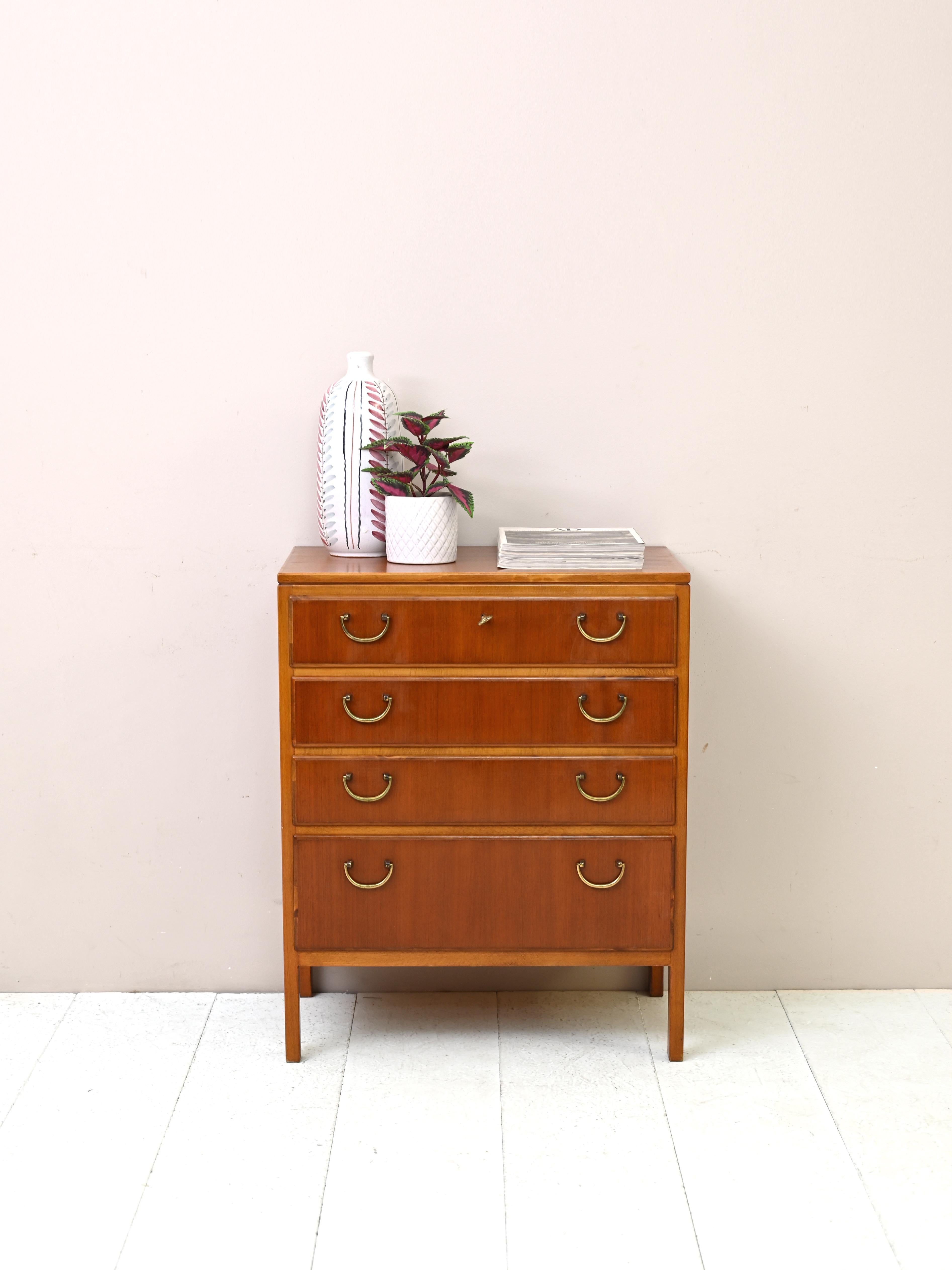 Vintage 1950s cabinet with drawers produced by Nordiska Kompaniet.
A beautiful piece of Scandinavian furniture in teak and mahogany with brass details designed by the well-known
designer David Rosén.

Good condition. It has been restored with