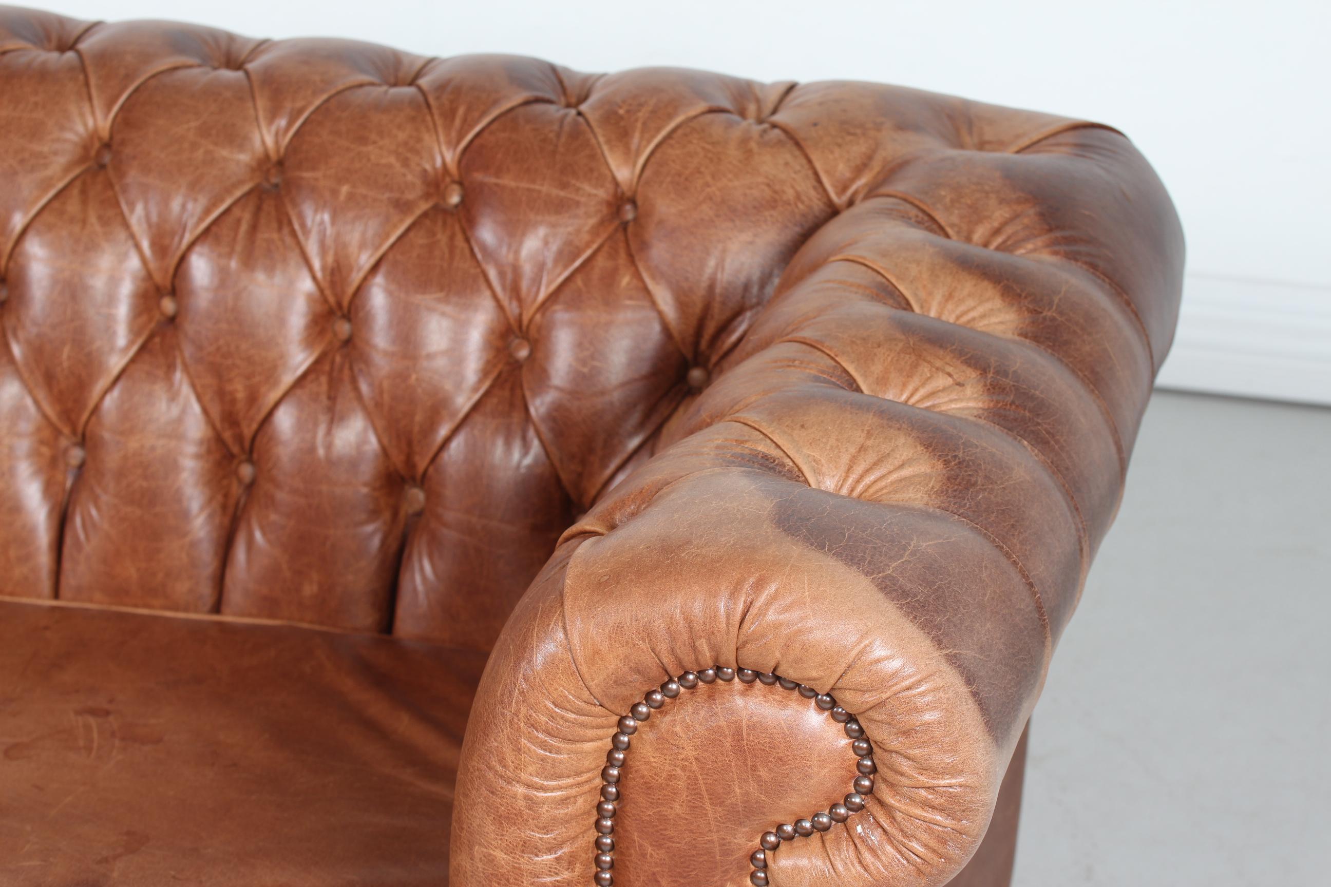 Vintage 3-seat Chesterfield sofa made in the 1970s.
It's upholstered with delicate and good quality cognac colored leather with numerous buttons. 

Measures: Length 188 cm
Height 72 cm
Seat height 43 cm
Depth 90 cm

The sofa is in good