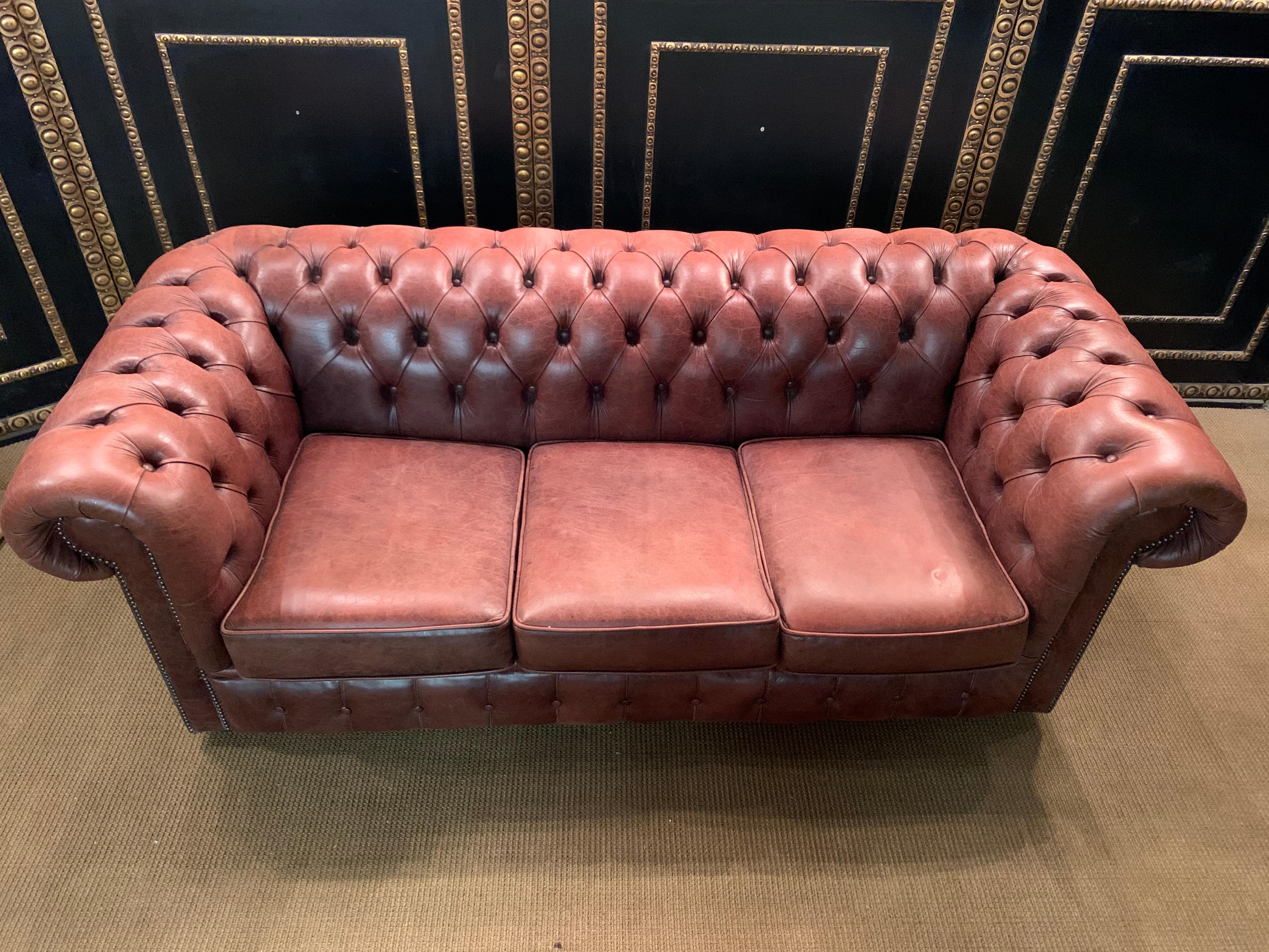 This original beautifully preserved Cognac leather three-seat sofa is very masculine. Coil sprung feather filled cushions - Vintage Cognac leather Chesterfield sofa with original coil sprung front edge and feather filled cushions. Please note all