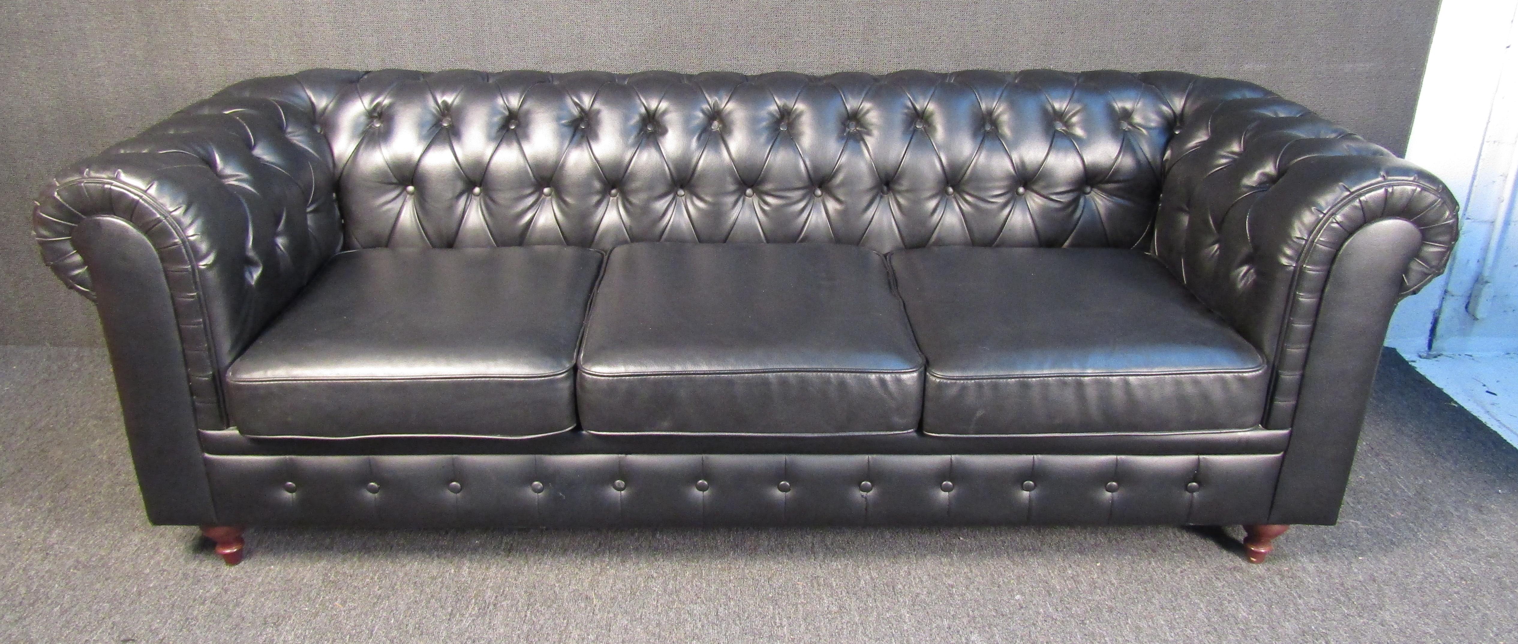 Long tufted sofa with wood legs.
(Please confirm item location - NY or NJ - with dealer).
 