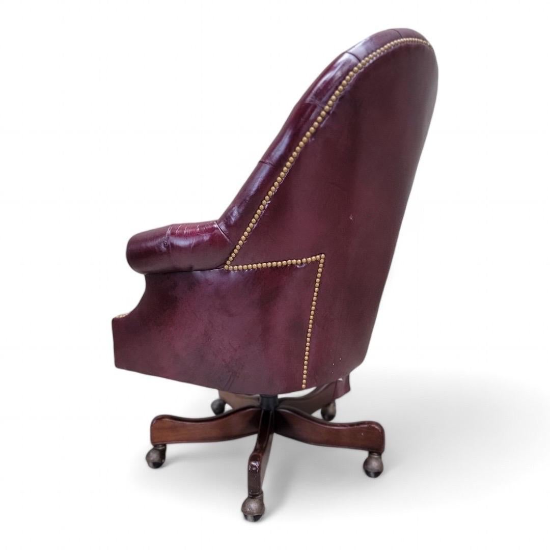 Vintage English Chesterfield Tufted Burgundy Leather Tilt Executive Desk Chair with Nailhead Finish and Casters by Hancock and Moore 

The Vintage English Chesterfield Tufted Burgundy Leather Tilt Executive Desk Chair by Hancock and Moore combines