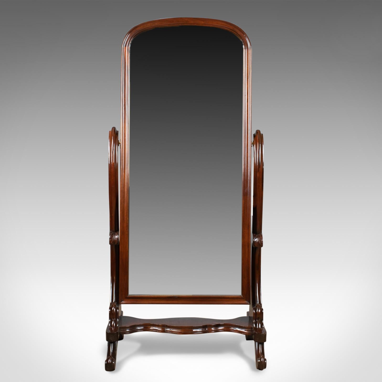 This is a vintage cheval mirror, an English, Victorian revival, full length dressing mirror, tilting in mahogany stand dating to circa 1970.

Large quality mirror plate
Mounted in arched mahogany frame
Paneled back ideal for centre room
