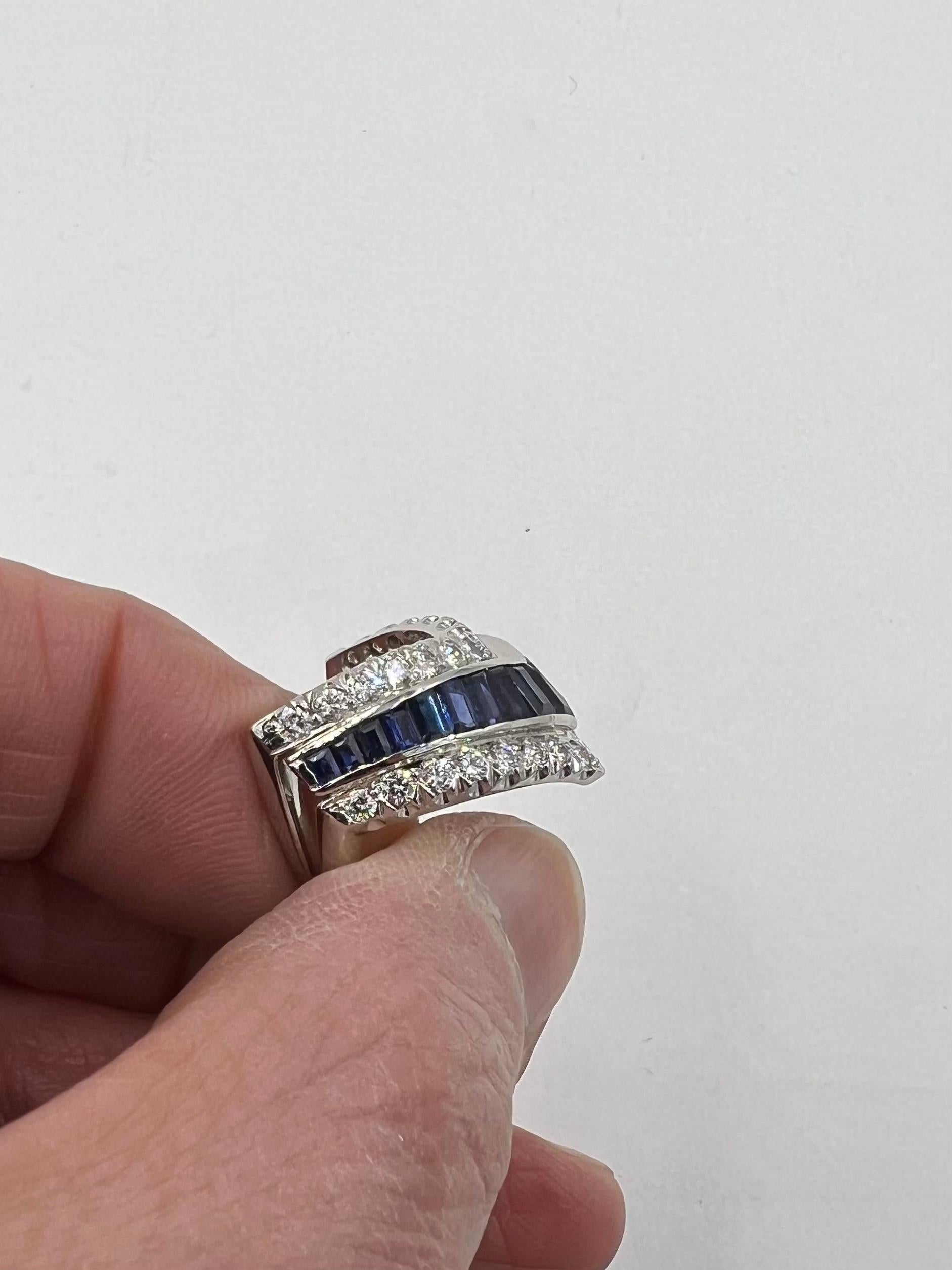 Vintage Sapphire and Diamond platinum chevron band ring circa 1950

ABOUT THIS ITEM:  R-DJ310H

           A very unusual vintage chevron ring with calibrated cut Sapphires and two rows of round brilliant cut diamonds, one on each side of the