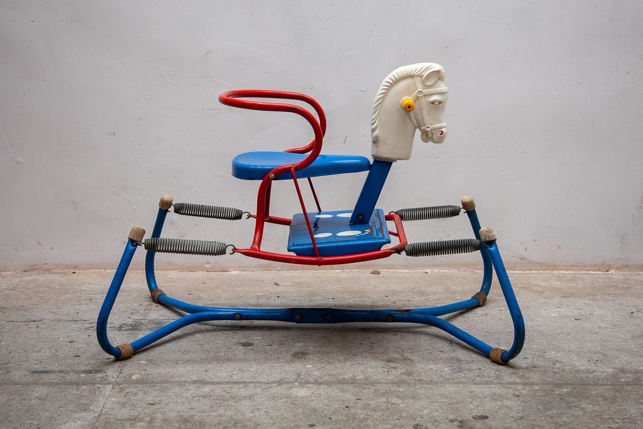 Vintage MOBO metal rocking horse 1960's This Rocking Horse was made in England by D.Sebel & Co LTD Mobo Toys. This metal horse toy is standing on a frame with springs to rock. With a blue saddle and frame and a white plastic horse head. A midcentury