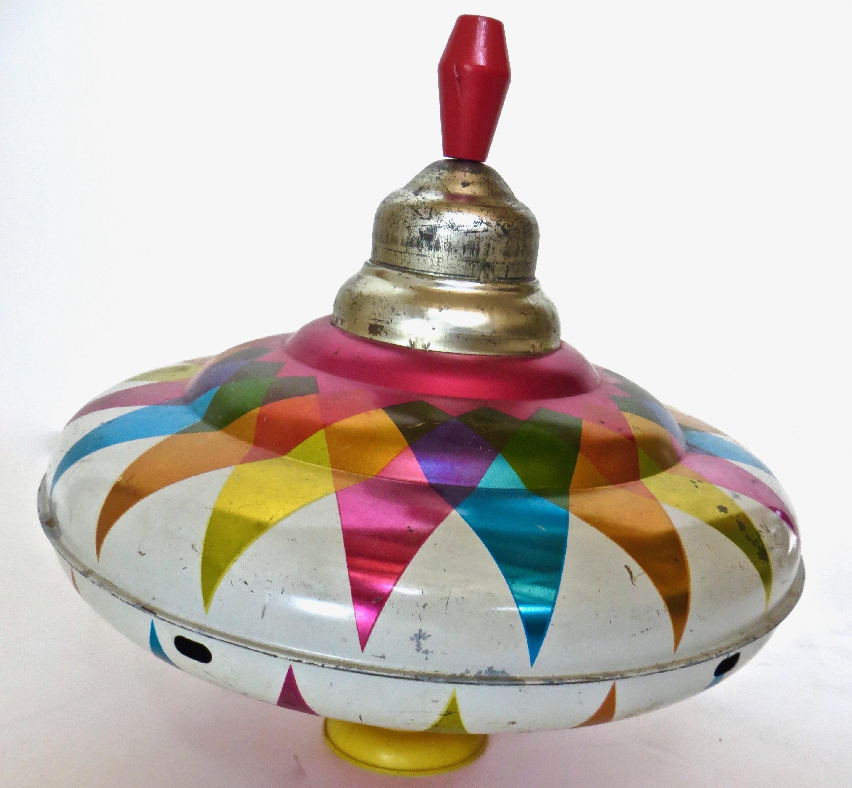 Highly colorful and completely operational hard to find LARGE tin child's toy spinning top made by the J. Chein Company, Harrison, New Jersey, Circa 1950. It works great and is in completely all original condition and authentic with no repairs, no