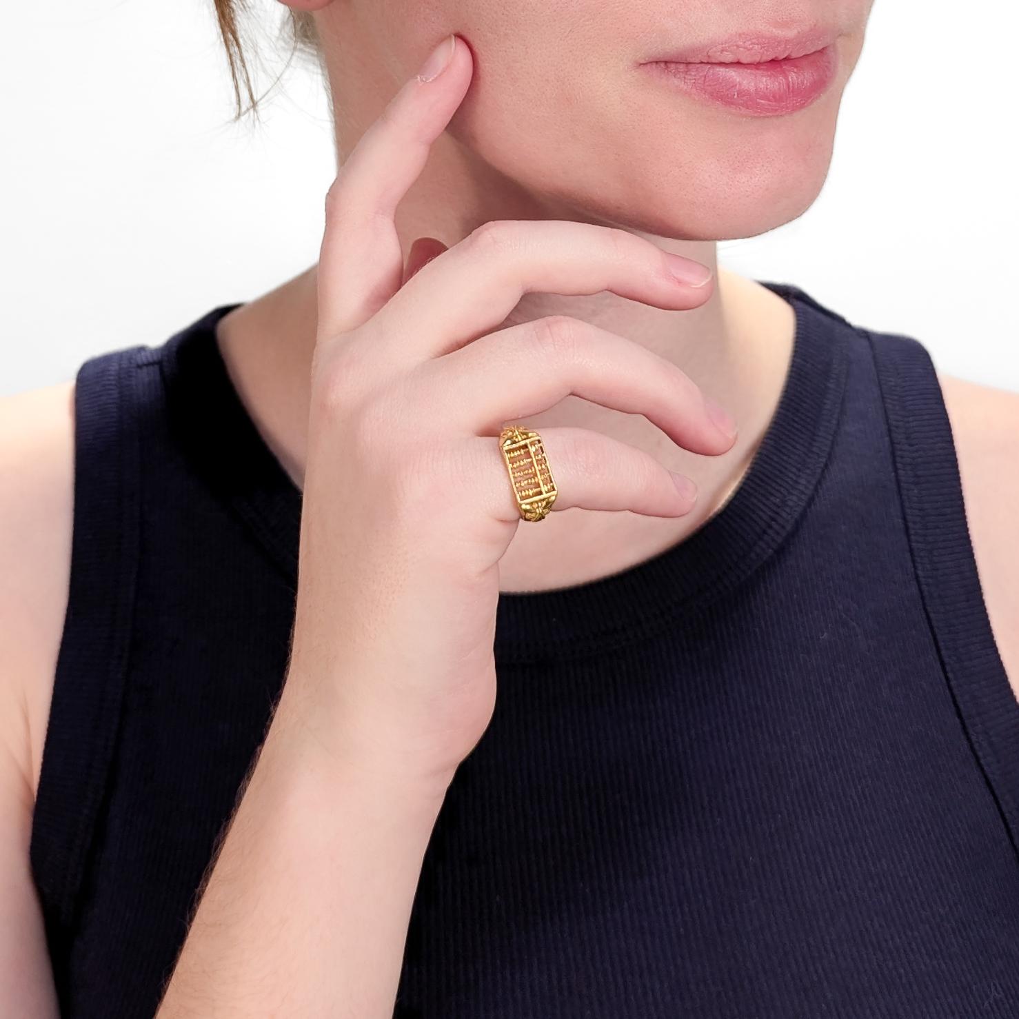 A fine Chinese gold ring.

In 18 karat yellow gold.

The ring designed with a functional abacus with moving beads to its head.

With embossed butterfly decoration to the shoulders and tapered shank.

Marked to the shank.

Simply a wonderful Chinese