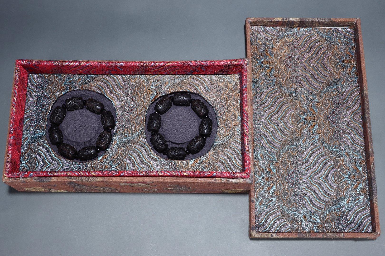 This Vintage Chinese Agarwood Carving Dzi Guanyin Beads Bracelets Pair is a rare and spiritually significant set, combining the natural beauty of agarwood with the powerful symbolism of Dzi beads and the compassionate presence of Guanyin, the