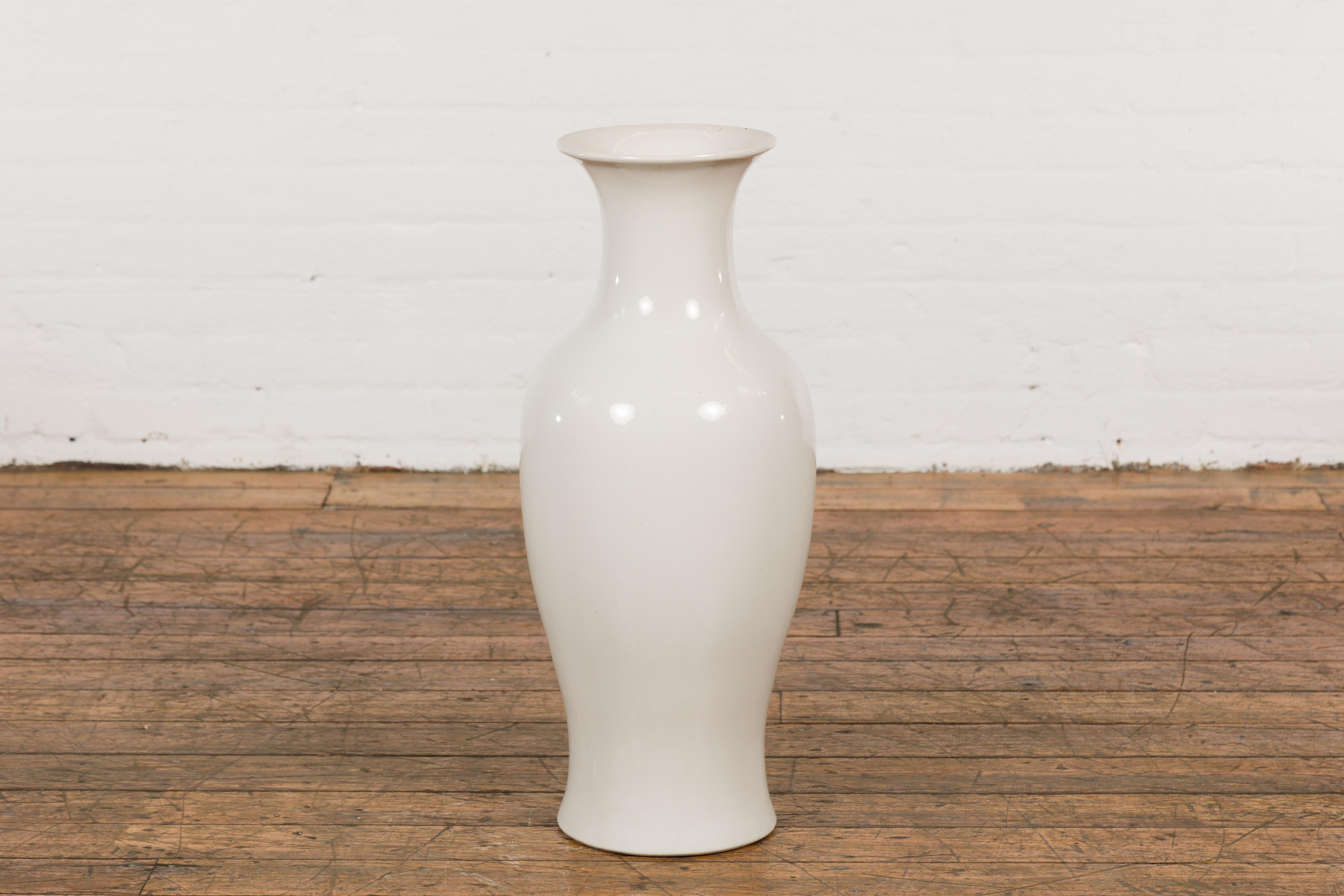 A Chinese vintage blanc de Chine altar vase from the mid 20th century, with flaring neck. Experience the timeless elegance of traditional Chinese craftsmanship with this vintage mid-20th century Blanc de Chine altar vase, featuring an artfully