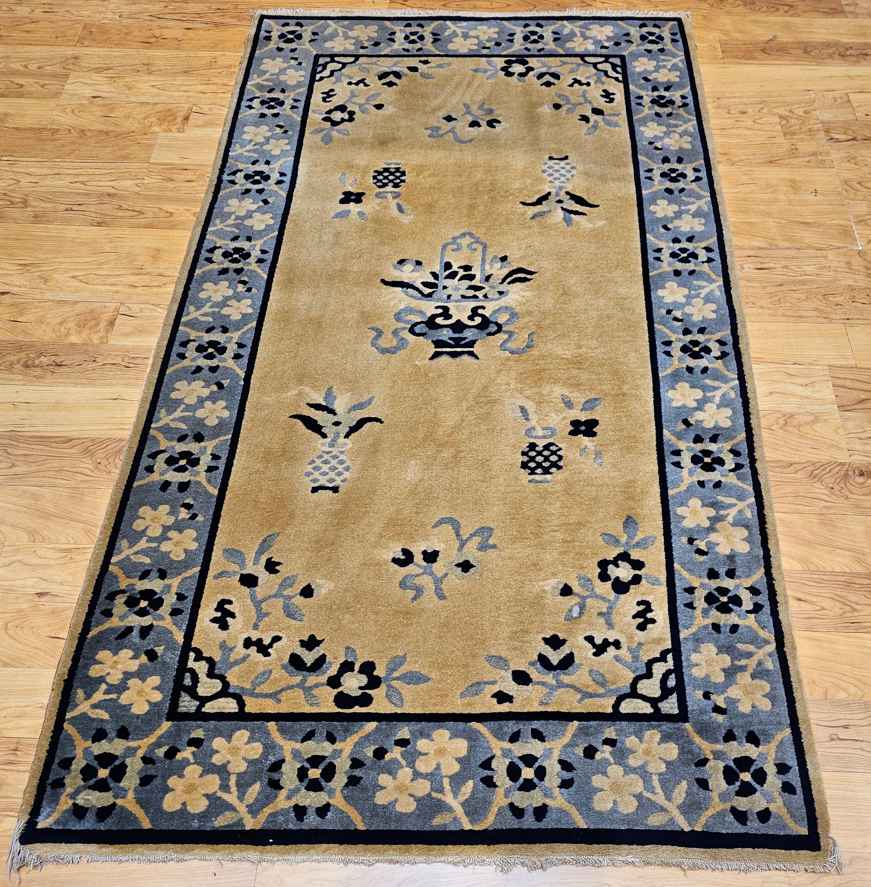 Graceful and timeless, this vintage Chinese Art Deco rug from the early 1900s showcases a serene tan wool field beautifully framed by a soft baby blue border. Hand-knotted with care, the rug exemplifies the elegant simplicity and bold design typical