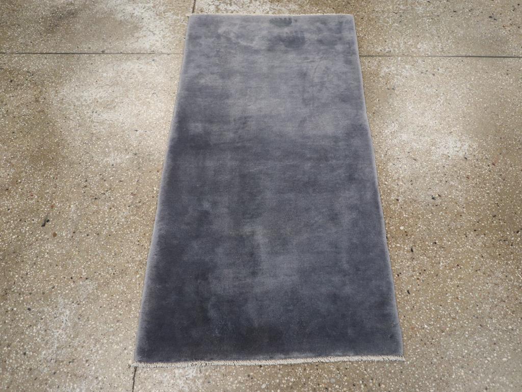 This mid-20th century Chinese Art Deco rug, measuring 2' 3