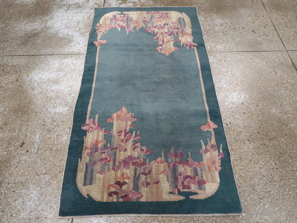 This mid-20th century Chinese Art Deco rug, measuring 3' 1