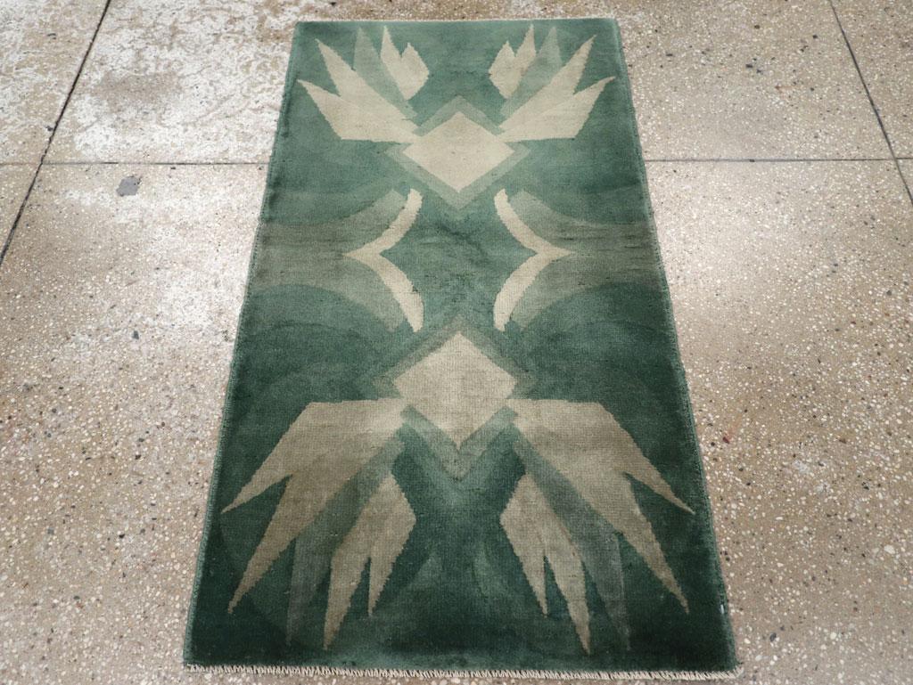 This mid-20th century Chinese Art Deco rug, measuring 2' 0