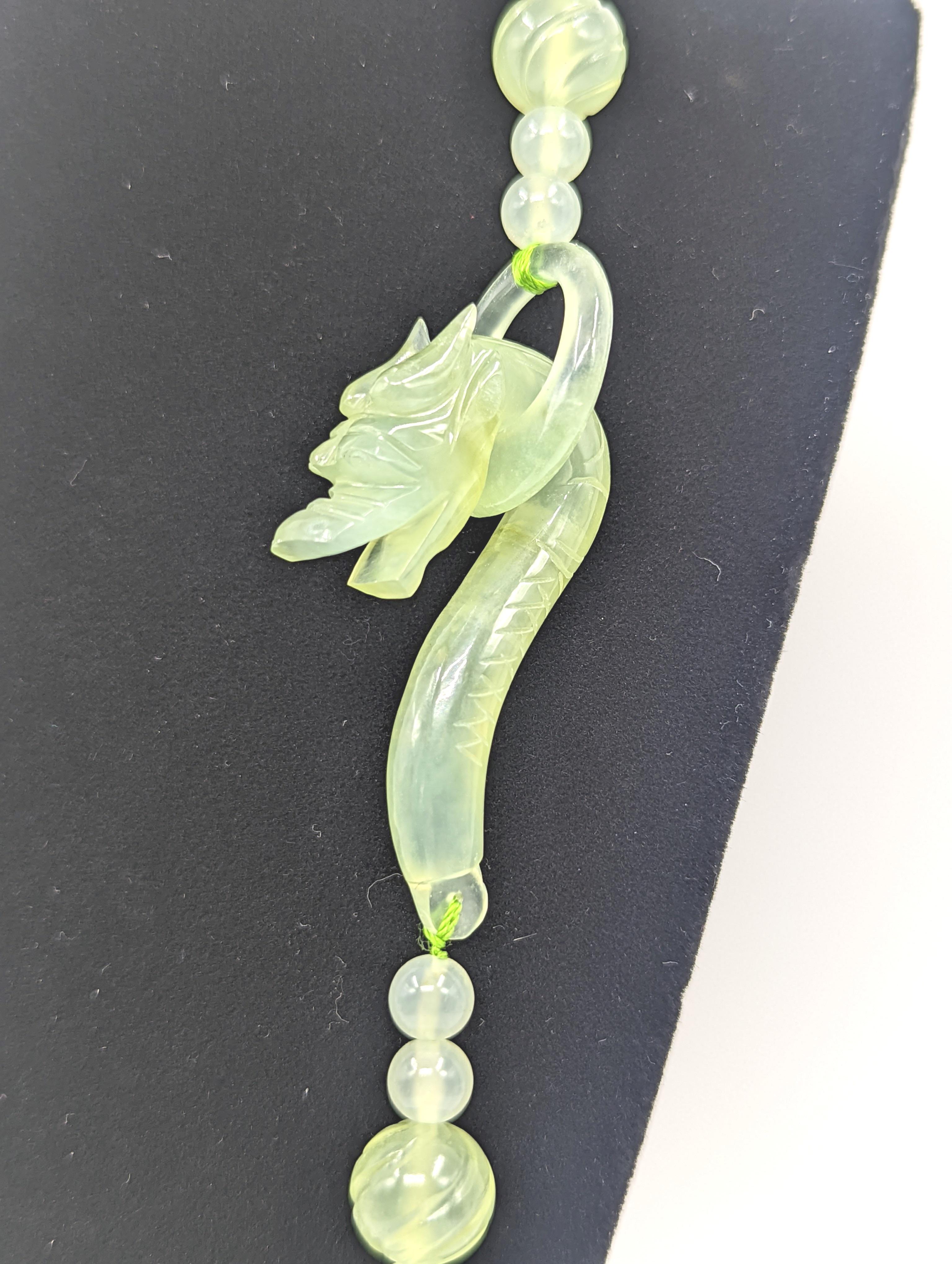 A vintage 1970s Chinese Arts & Crafts (H.K.) Ltd. carved 2 tone nephrite jade beaded necklace with carved dragon head clasp, highly translucent material, total length 29”.

Around since 1959, Chinese Arts and Crafts is where Hillary Clinton and