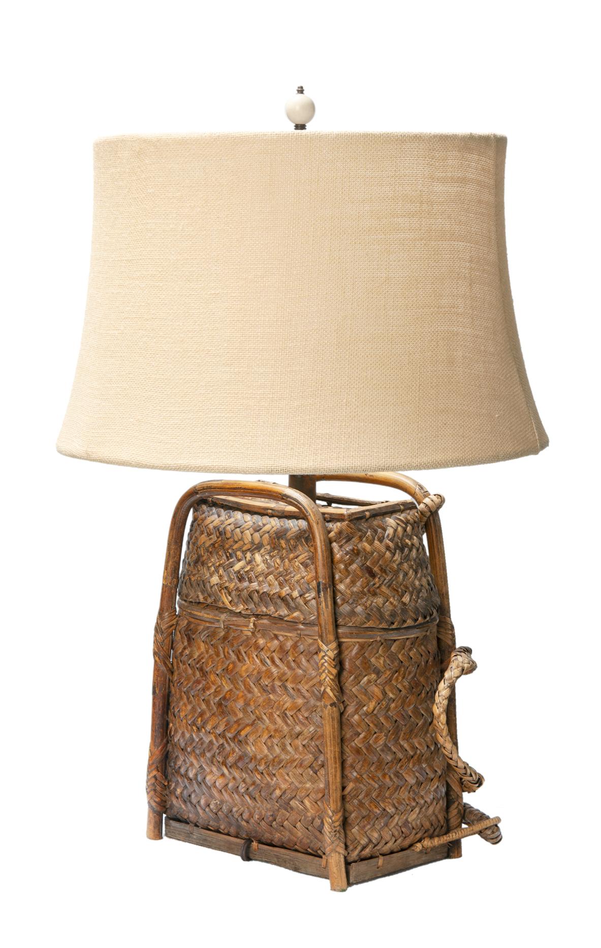 Custom made table lamp created from a vintage Chinese bamboo backpack.
Finial & new burlap shade are included.