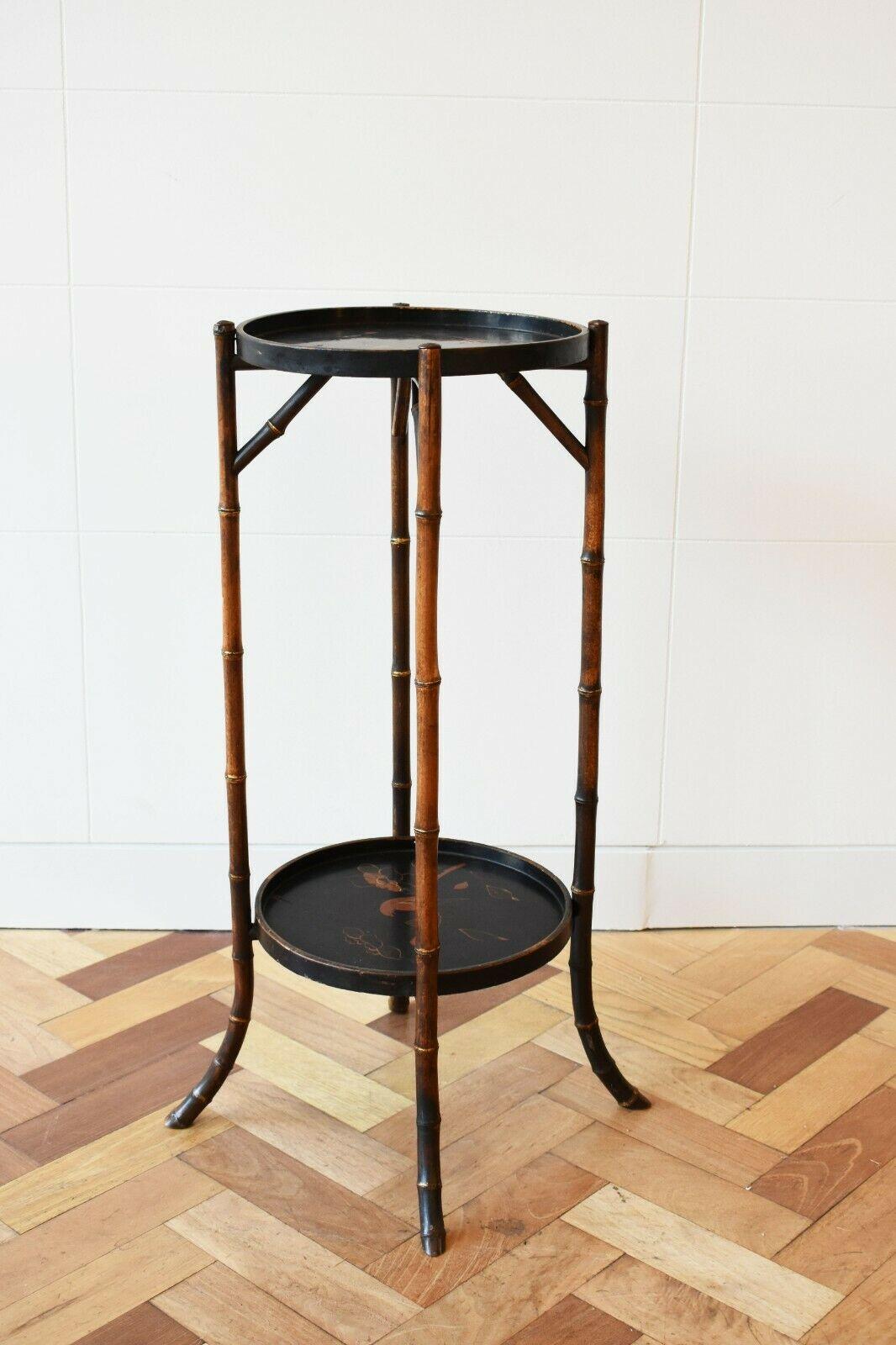 Vintage late 19th century Chinese bamboo two tier occasional table. 

This rare and unique piece features two hand-painted ebonised trays, depicting beautiful oriental birds and flowers. Set upon elegant and delicate bamboo legs, the bottom tray