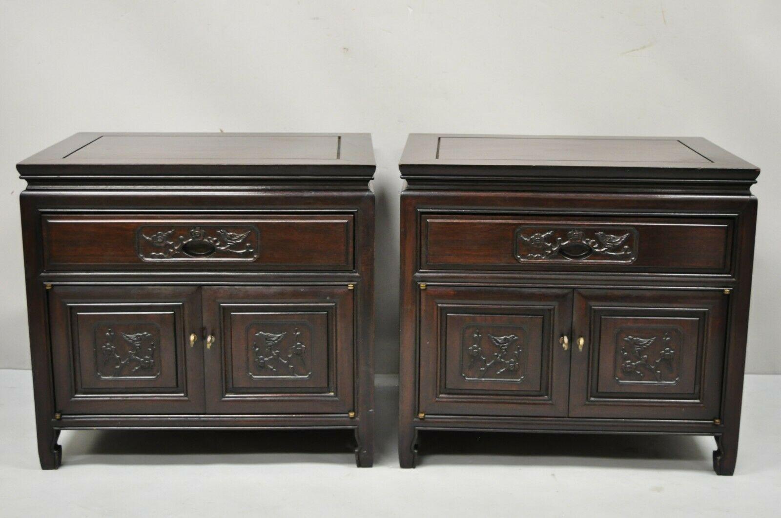 Vintage Chinese bird carved mahogany hardwood Asian Oriental nightstand - a pair. Item features bird carved fronts, solid wood construction, beautiful wood grain, nicely carved details, 2 swing doors, 1 dovetailed drawer, very nice vintage pair,