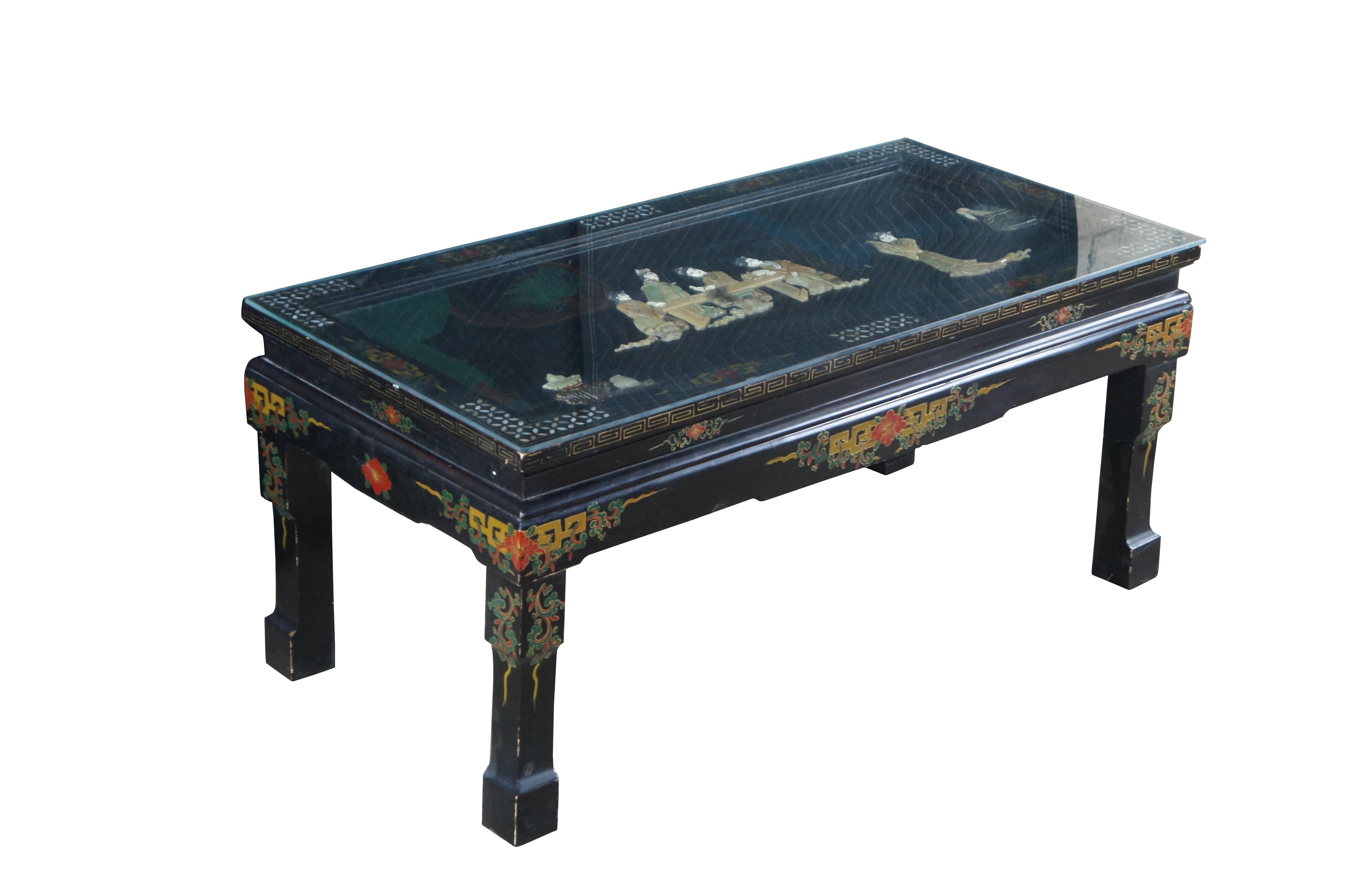 A beautiful hand painted Chinese folding coffee table, circa 1960s.  Features a hardwood frame with black lacquer finish decorated with soapstone figures and mother of pearl inlay.  The table features a rectangular form with inset top showcasing a
