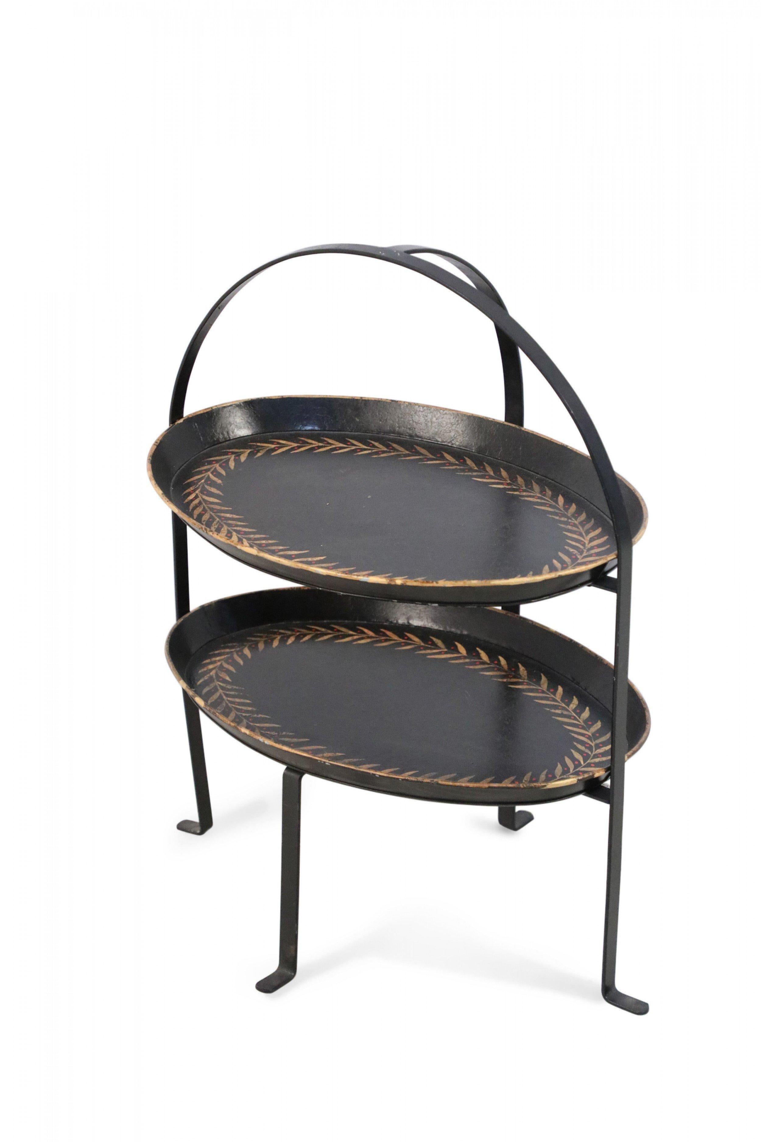 Vintage Chinese black tole, two-tiered server with a black metal frame holding two oval shelves decorated in a garland border of gold leaves with red dots (Available in green: NWL2450).