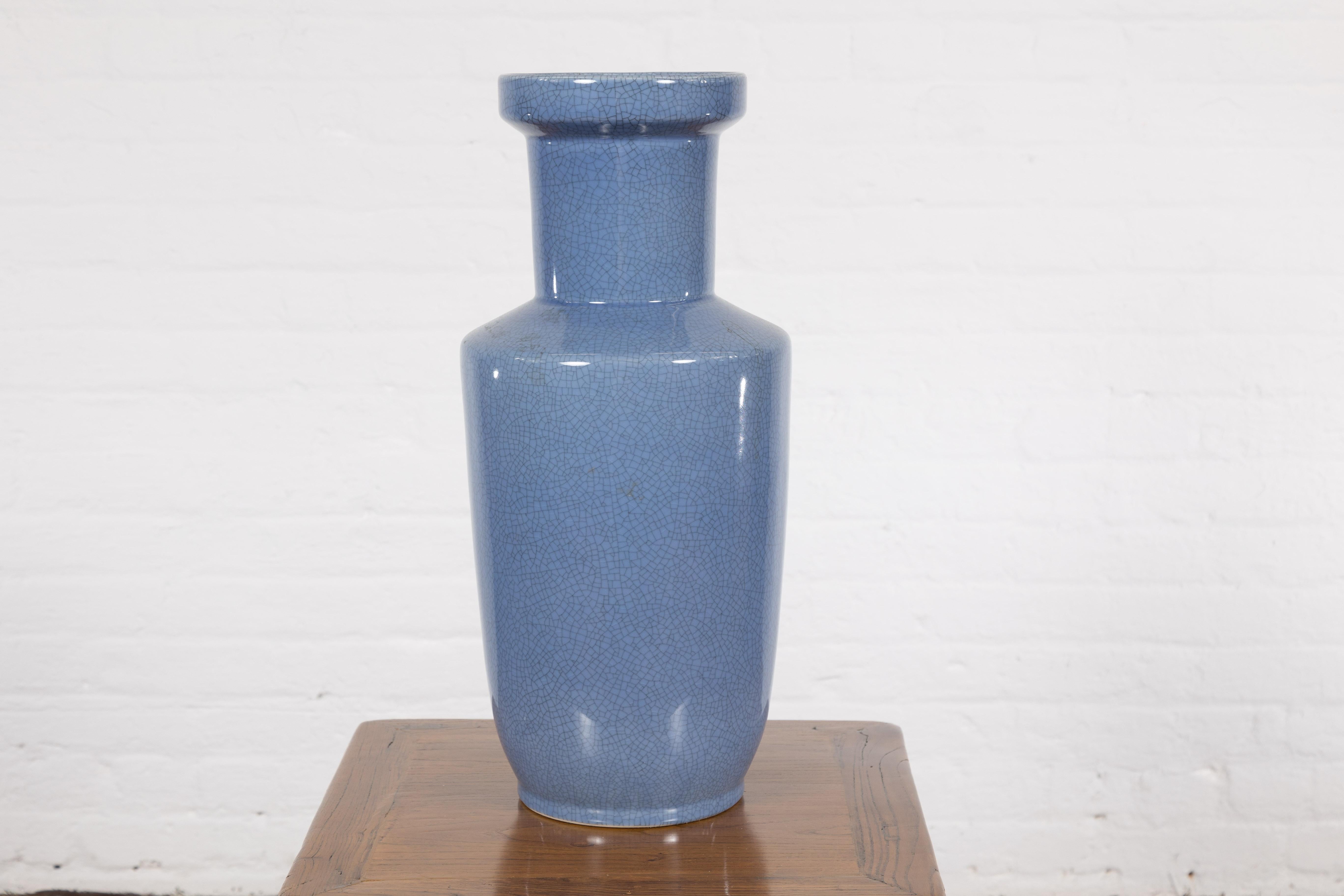 A vintage Chinese altar vase from the mid 20th century with blue crackle décor. Embrace an air of serene elegance with this vintage Chinese altar vase, hailing from the mid-20th century. Cloaked in an entrancing blue crackle décor, this vase is a