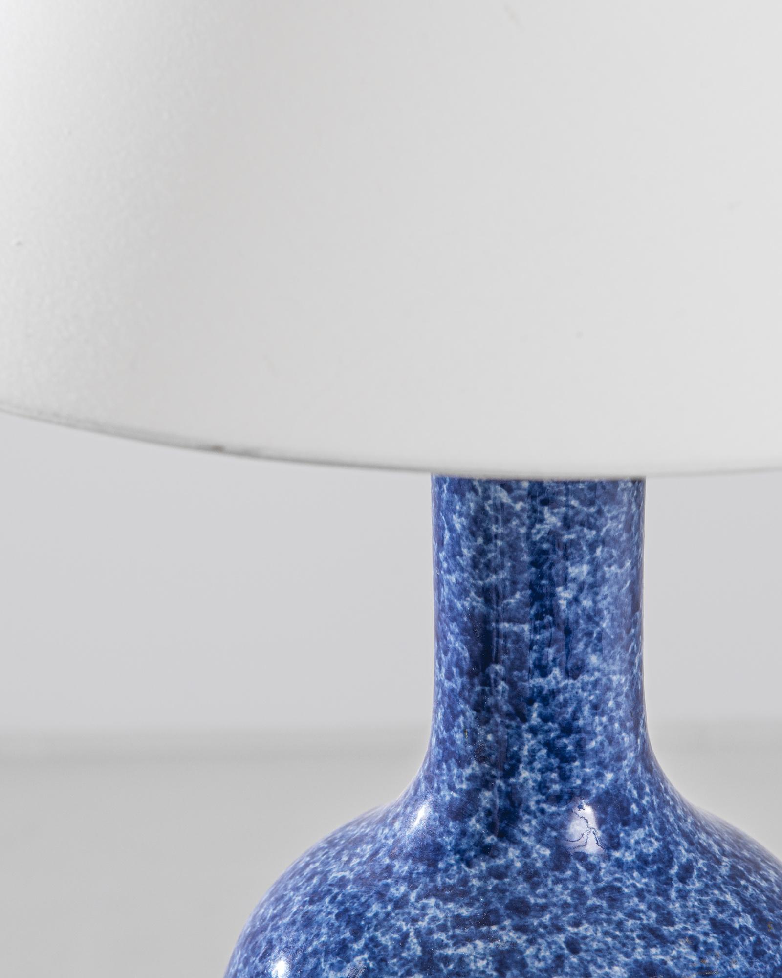 An extraordinary piece to inspire your collection. This vintage Chinese “globular shape” vase has been adapted into a beautiful table lamp. Polished brass meets the speckled white and blue glaze, enlightening your space with an uncompromising