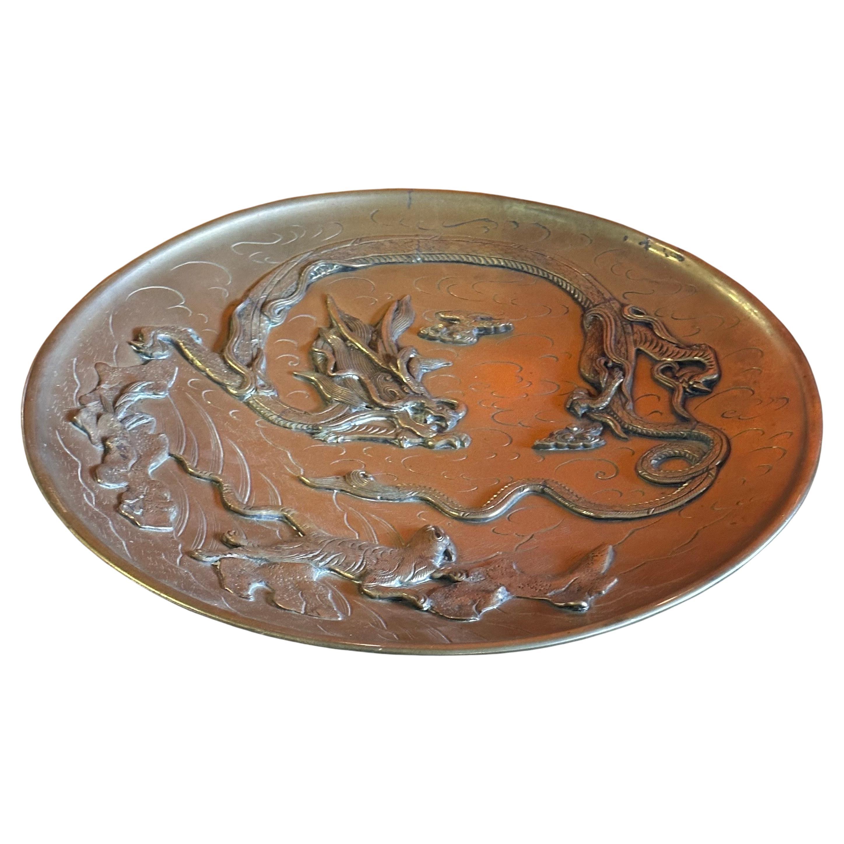 Superb vintage Chinese brass bas-relief dragon charger, circa 1940s.  The piece is in very good vintage condition and measures a hefty 14