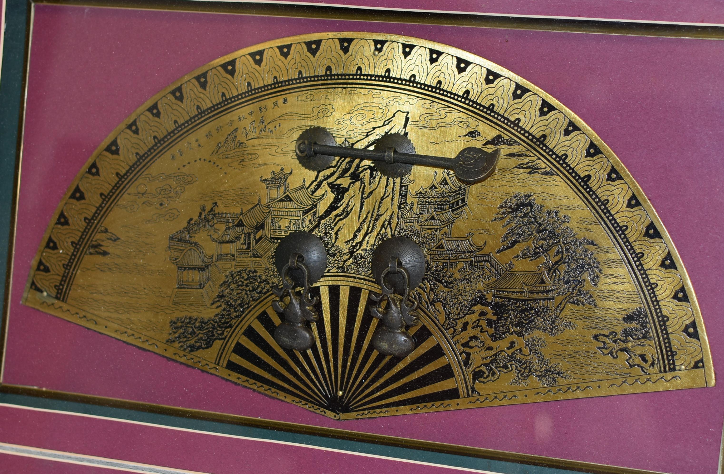 A vintage shadowbox of solid brass hardware. The exceptionally large fan-shaped door plate is prominently featured, displaying great details of a finely engraved celestial scene. Pavilions with immortals standing in the court yard looking out to the