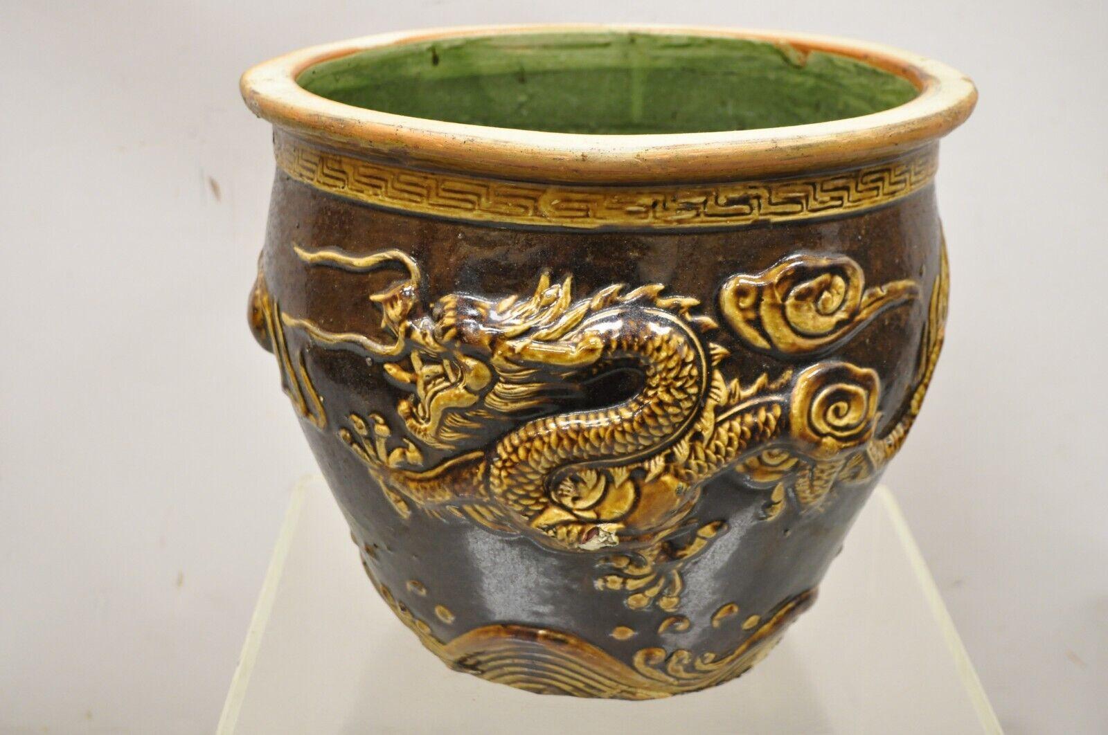 Vintage Chinese Brown Glazed Ceramic Dragon Cachepot Planter Pot - a Pair. Item featured has raised/relief designed dragons, brown glazed finish, very nice vintage pair, great style and form. Circa Early to Mid 20th Century. Measurements: 13