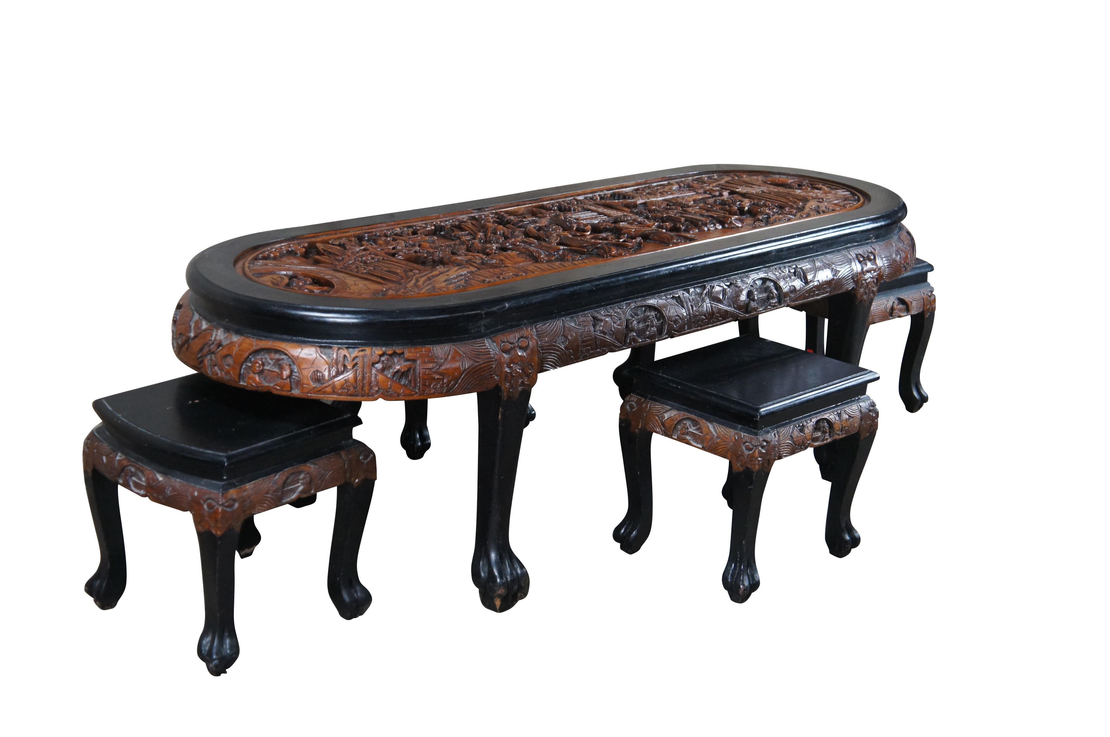 Vintage Chinese Chinoiserie oval coffee / cocktail / dining / tea table and four nesting stools.  Made of elm and black lacquer featuring a carved landscape scene with Emperor, dancing Geishas, pagodas, Cherry Blossom trees, dragon faces and claw /