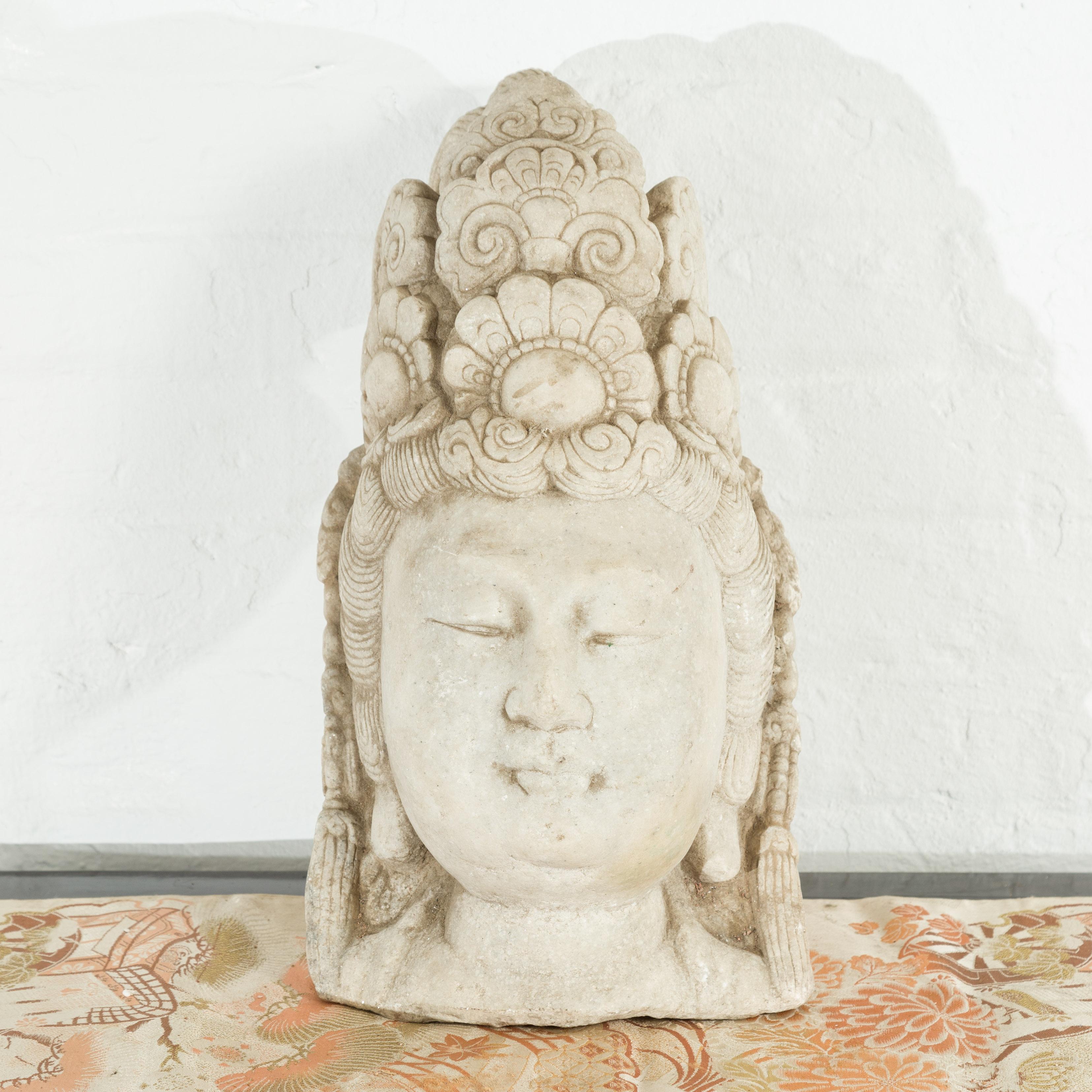 A Chinese vintage carved stone bust of Guanyin from the mid 20th century, with ornate headdress. Created in China during the midcentury period, this carved stone bust captivates us with its calm depiction of Guanyin, Bodhisattva of Compassion.