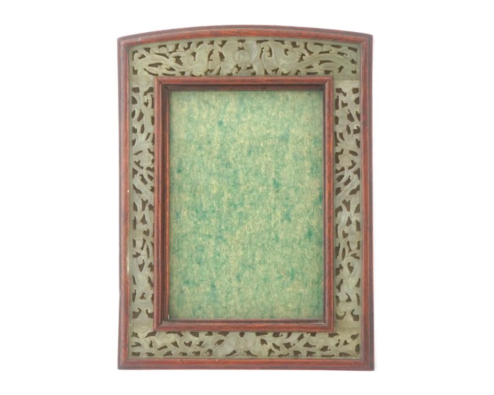 A vintage mahogany picture frame with an inlaid carved jade bevel intricately hand carved with scrolled foliage motifs, bamboo stems and two phoenix birds on top. Circa the 1960s. Desktop Accessories, Photo Frames, Gem Stone Carvings And Asian