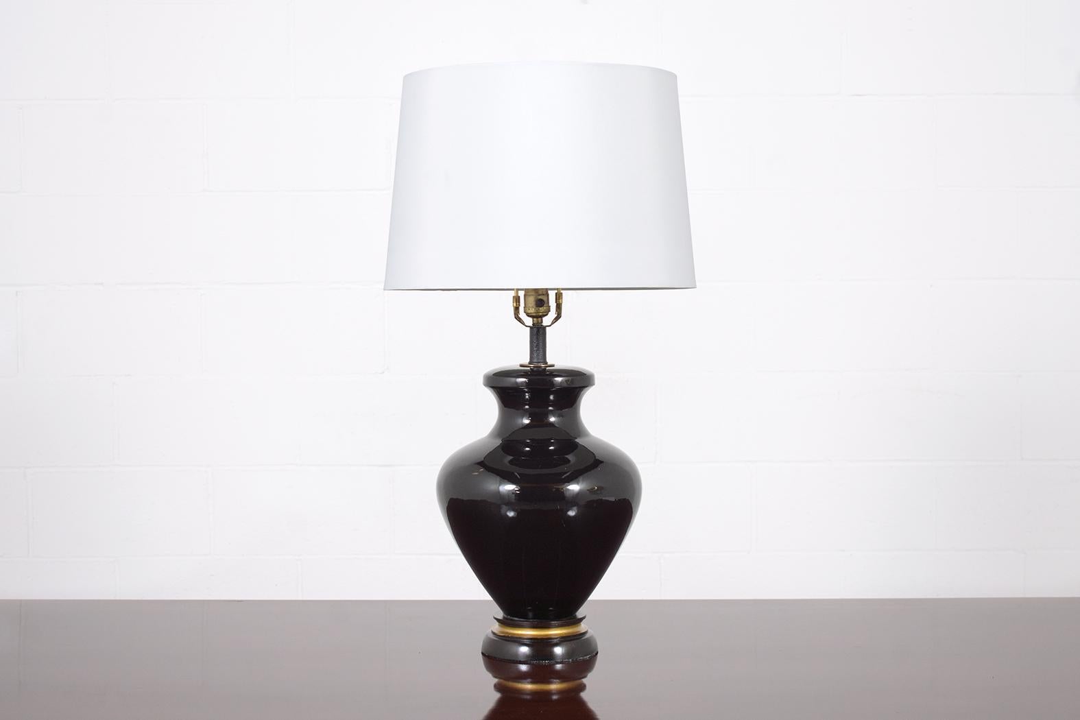Discover the allure of our authentic vintage Chinese table lamp, intricately crafted from top-quality ceramic and perfectly functioning. This remarkable piece features an urn vase design, adorned with an eye-catching, hand-painted deep black hue and