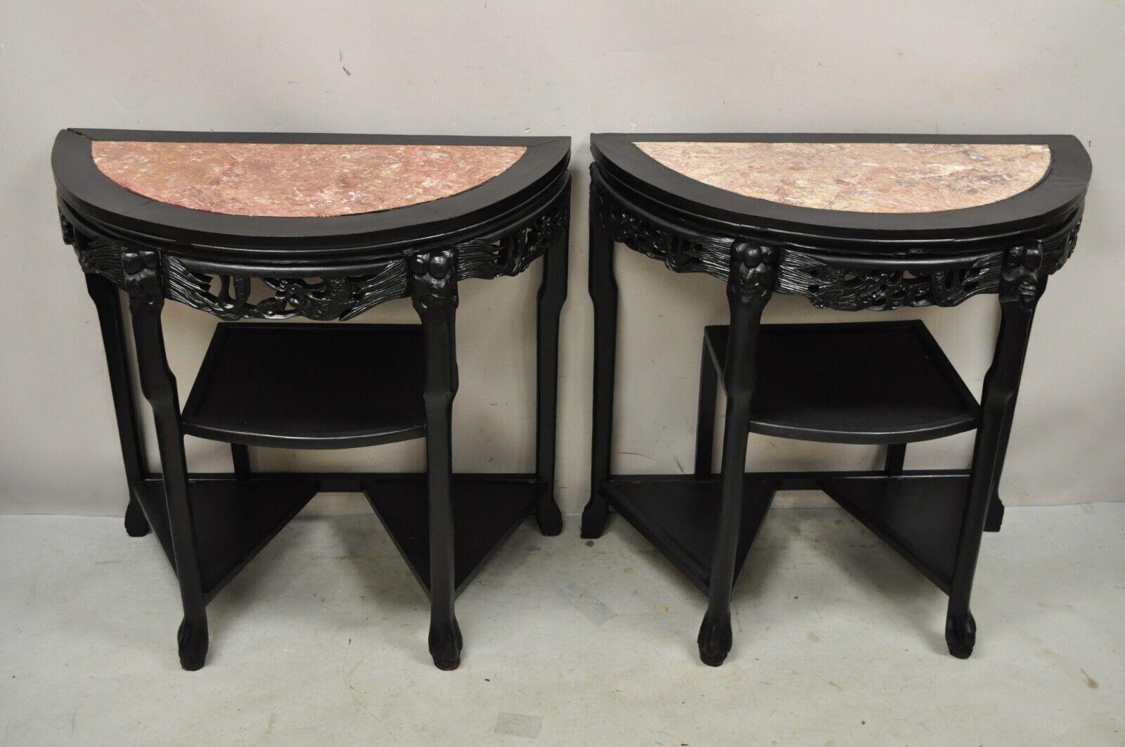 Vintage Chinese Chinoiserie Black Demilune Pink Marble Console Table - a Pair. Iem features a half round Demilune form, inset pink marble tops, figural carved details, multiple shelf tiers, very nice vintage pair, great style and form. Circa Mid to