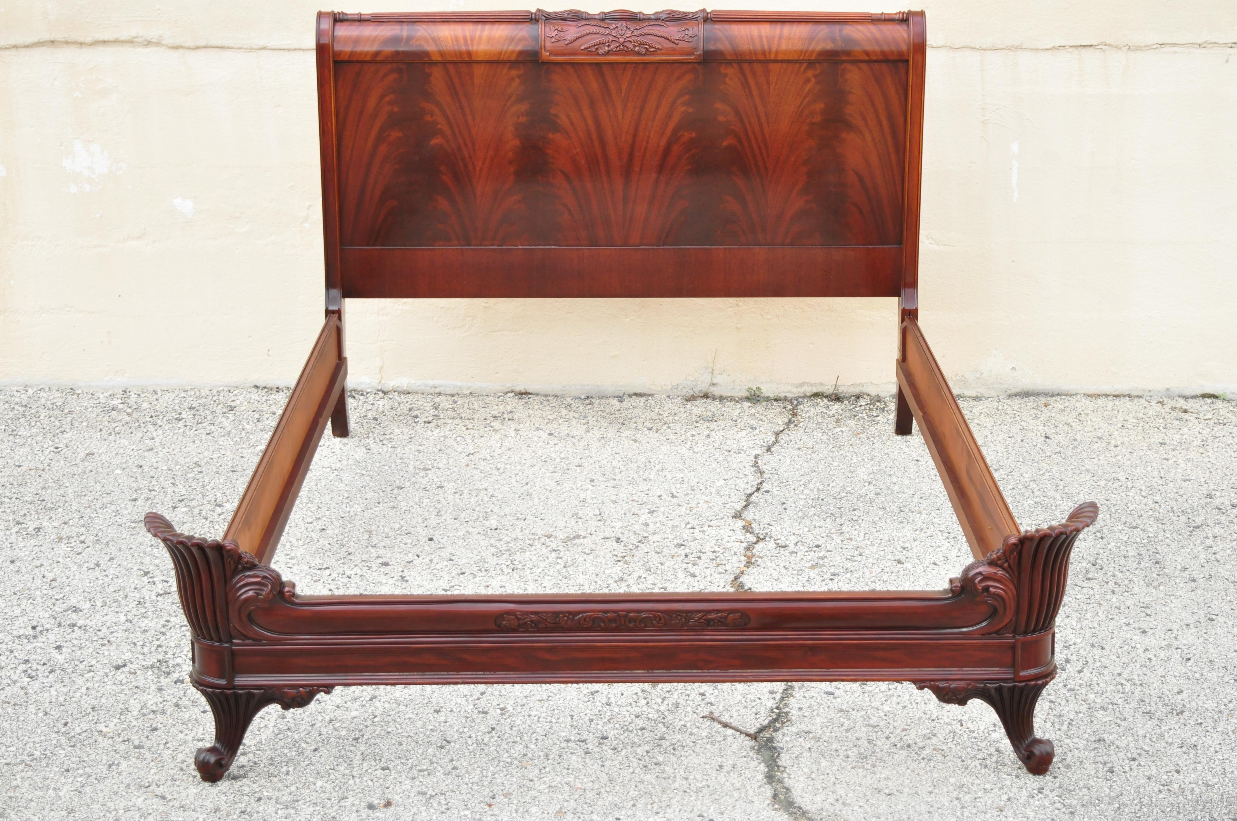 Vintage Chinese Chippendale mahogany carved wheat sheaf full size bed frame. Item features a wheat sheaf carved headboard, fan carved footboard, beautiful wood grain, quality American craftsmanship, great style and form, circa early to mid-20th