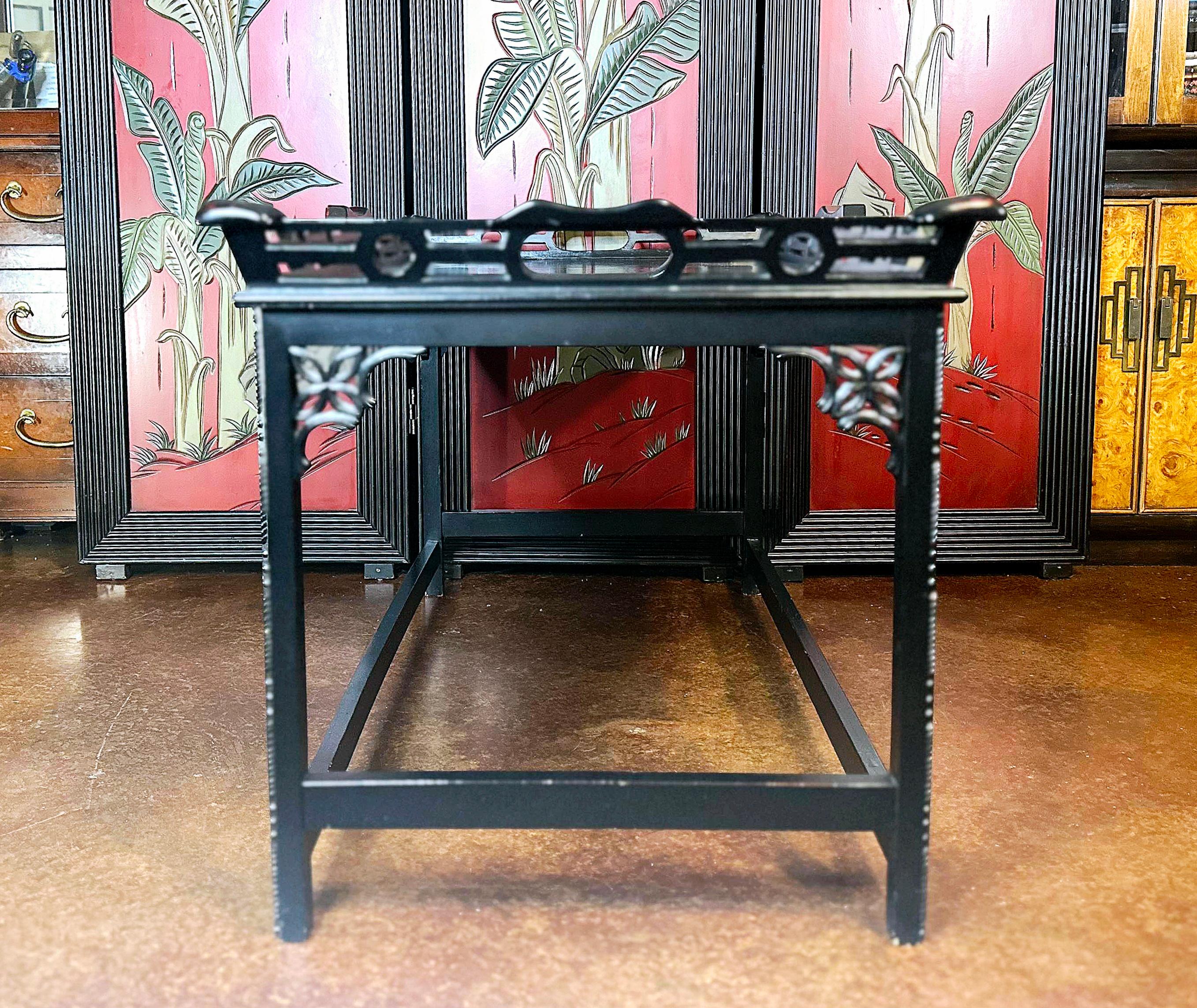 Classic Chippendale styling. 
Black ebonized coffee table. 
Lotus flower details in the supports joining the legs.
Intricate subtle carvings on the legs.
Would compliment a wide variety of styles. 
Hollywood Regency. 
Chinoiserie. 
Chippendale. 

